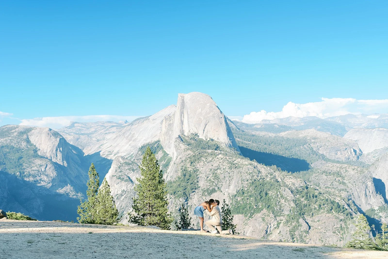 Couple kisses after their Glacier Point proposal