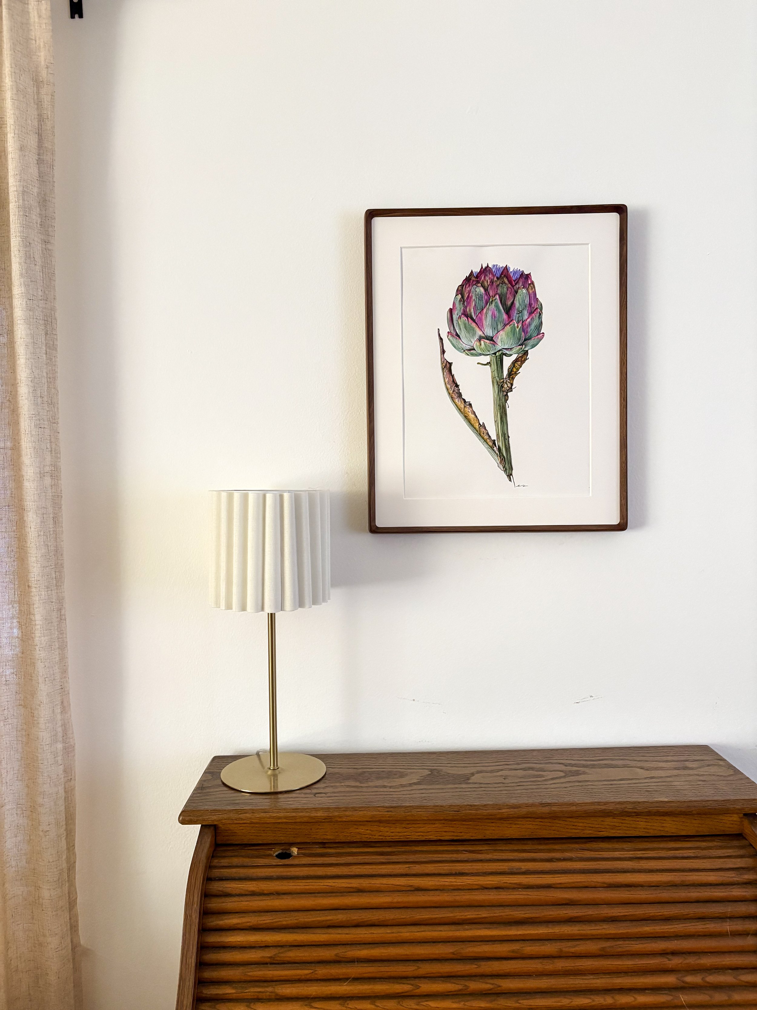 Original framed watercolor painting of a full stem artichoke in sage green and deep purple with a lilac flower at the crown, in a dark walnut wood frame