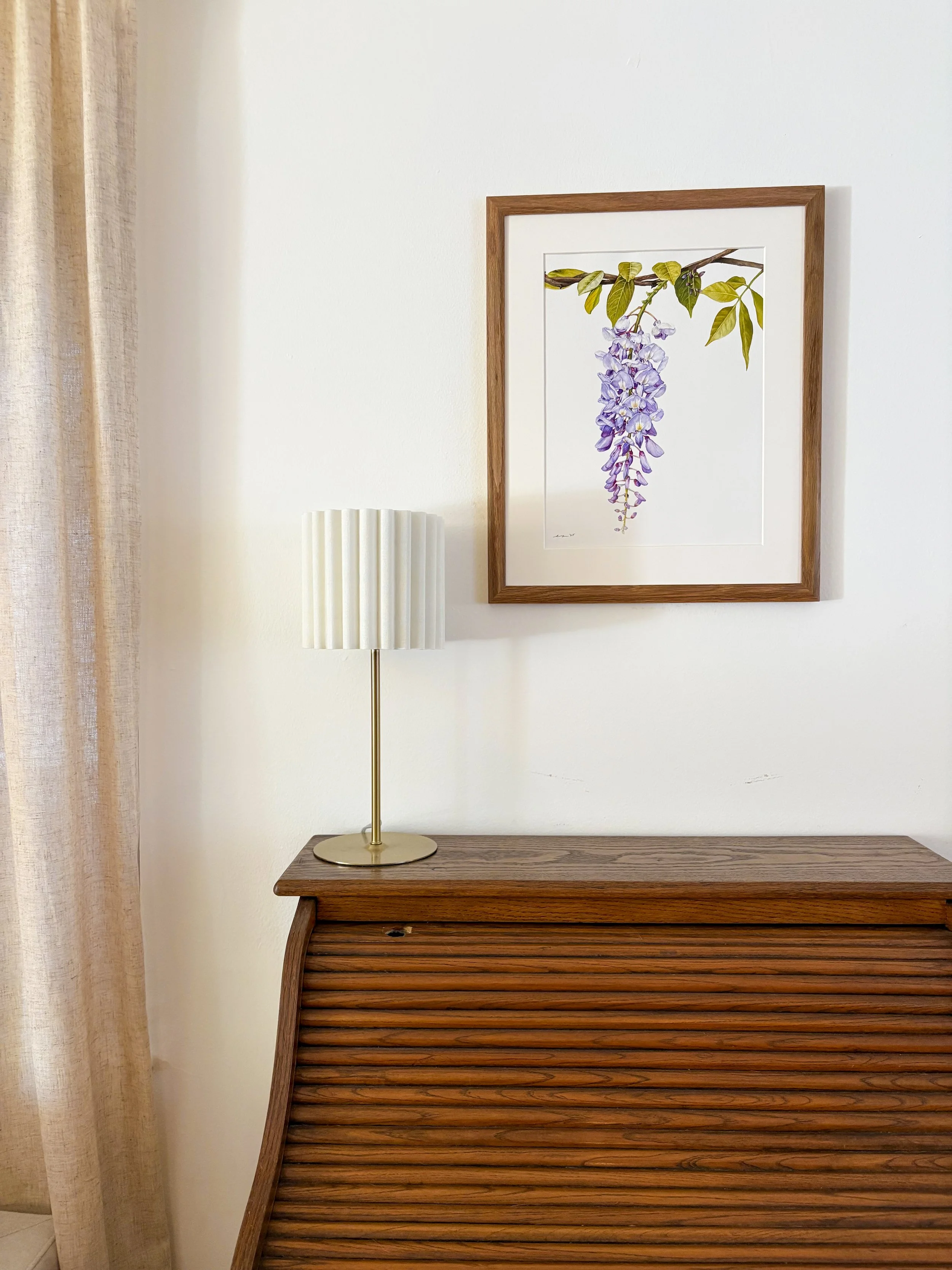 Original framed watercolor painting of a cascading wisteria bloom in periwinkle and lavender, hanging from a twisted branch with green leaves, warm wood frame