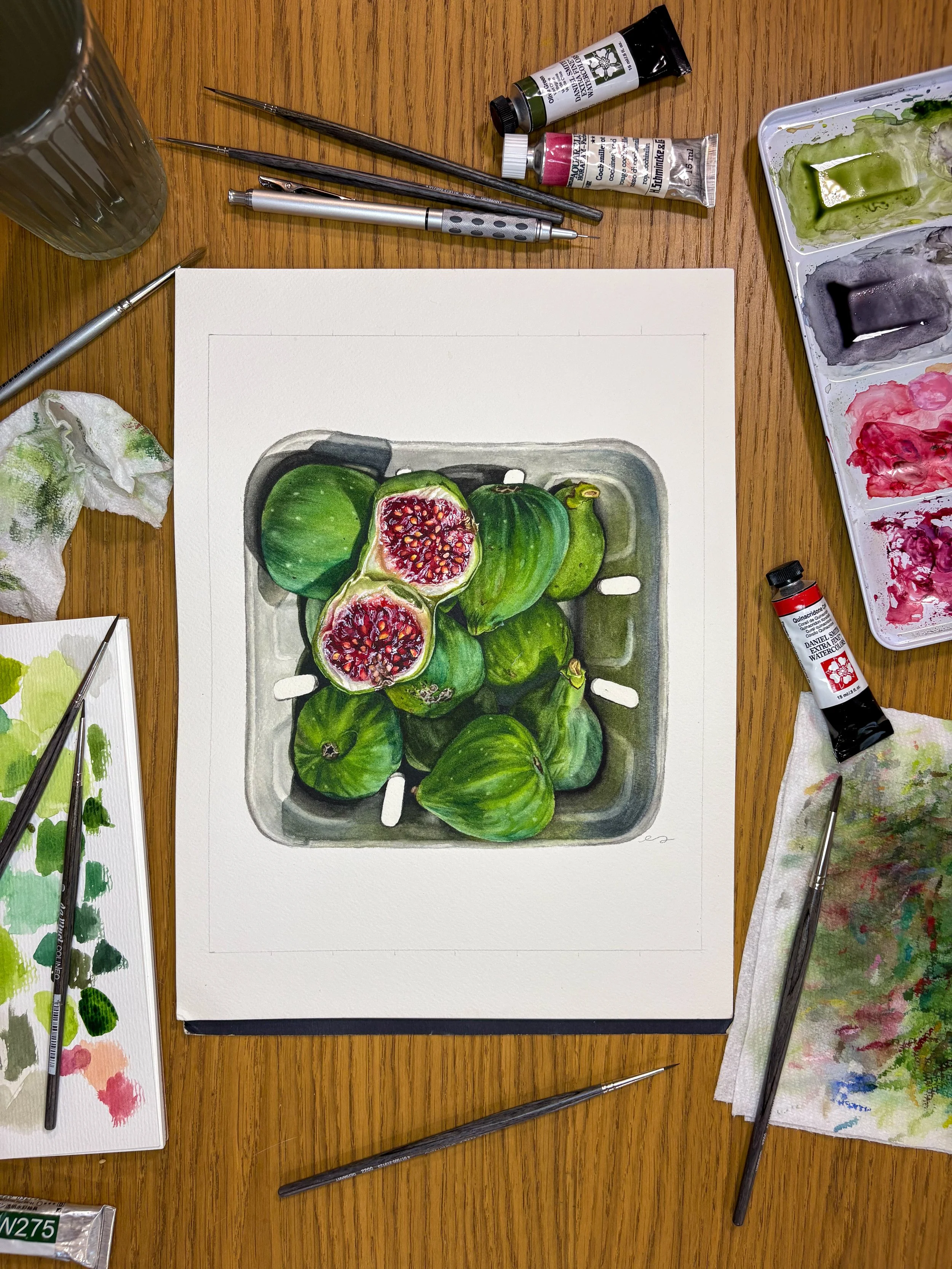 Original framed watercolor painting of green figs piled in a market container, two sliced open showing deep red centers, in a dark walnut wood frame