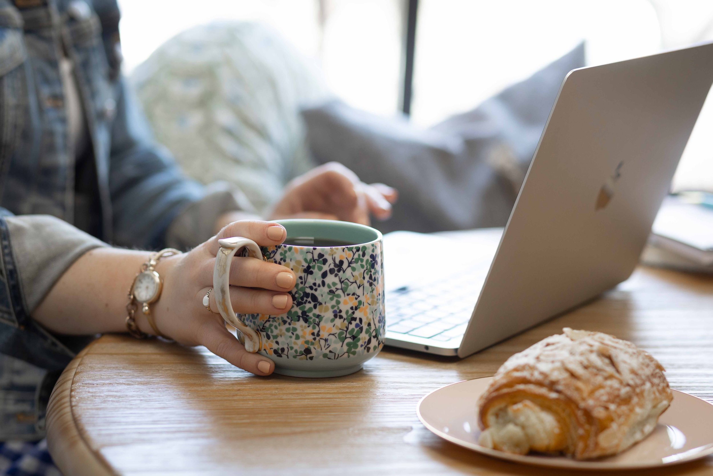 founder working with laptop coffee and pastry
