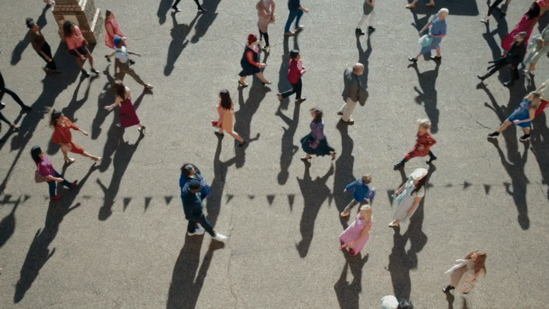 Cinematic outdoor scene with figures walking in sunlight casting long shadows in a narrative film environment, Rare Beasts, Billie Piper