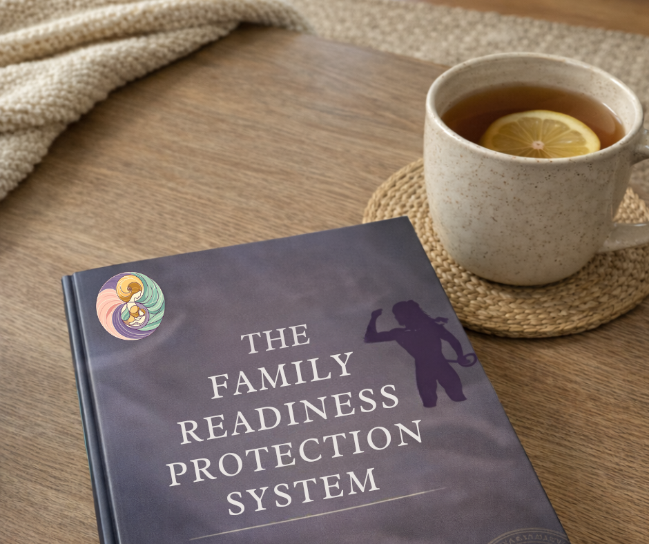 A book titled 'The Family Readiness Protection System' resting on a wooden table next to a cup of tea with a slice of lemon, on a woven coaster, with a beige knit fabric in the background.