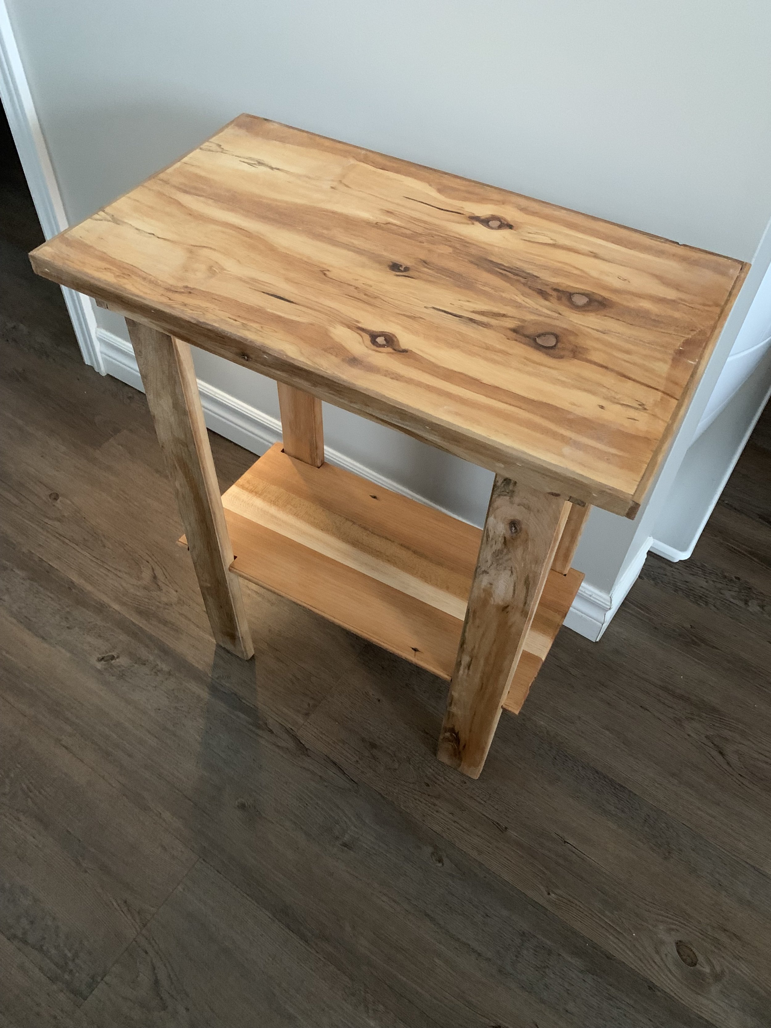 Top and Bottom are maple, while the legs and frame are oak.