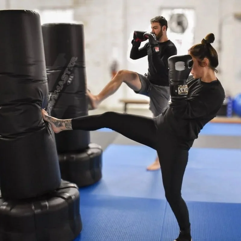 kickboxers hitting the heavy bag
