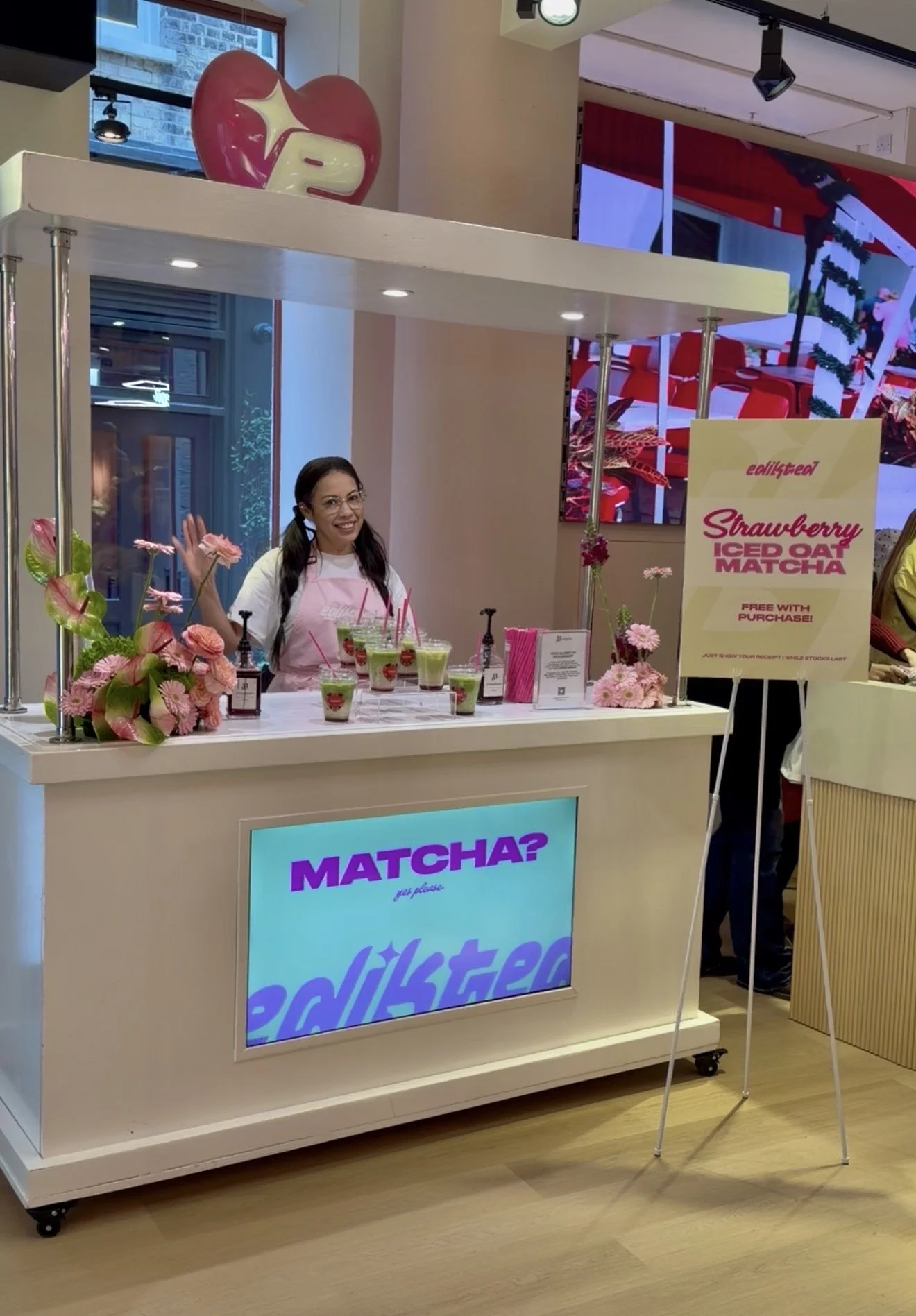 Edikted branded matcha cart with a strawberry iced oat matcha menu sign at an Edikted retail brand activation