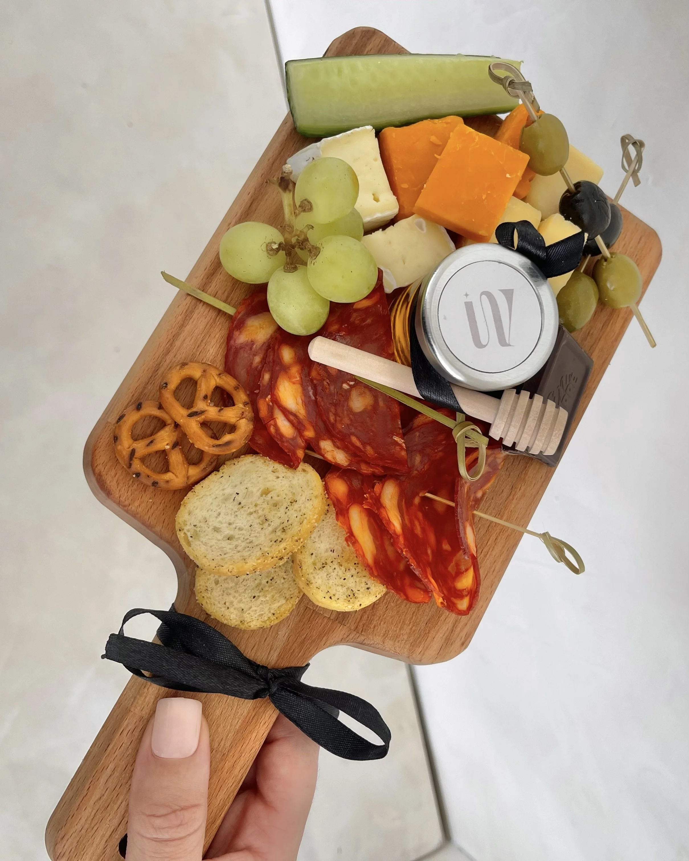 Beautifully presented charcuterie cart overflowing with cured meats, cheeses, and accompaniments.