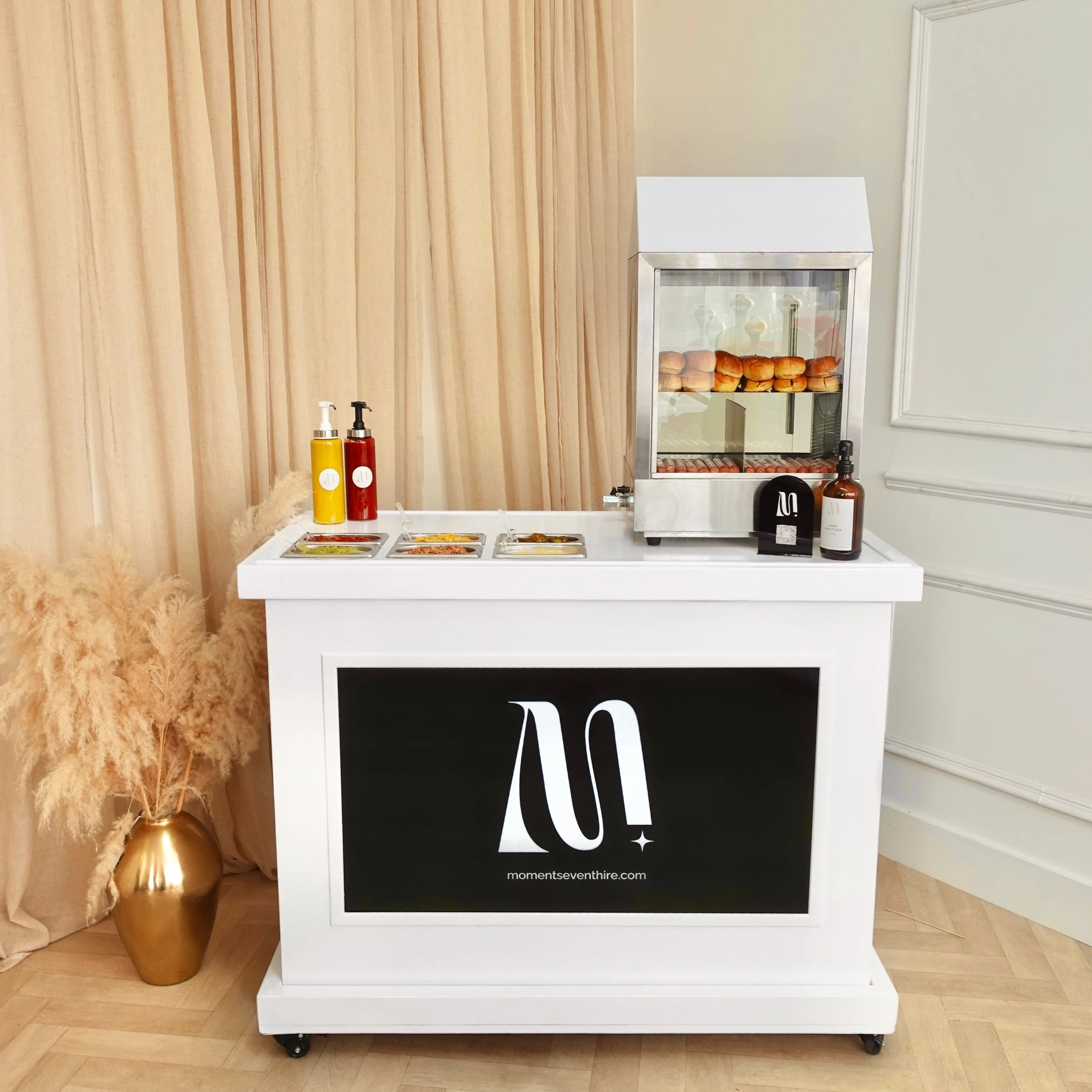 Hot dog machine on white cart with digital screen