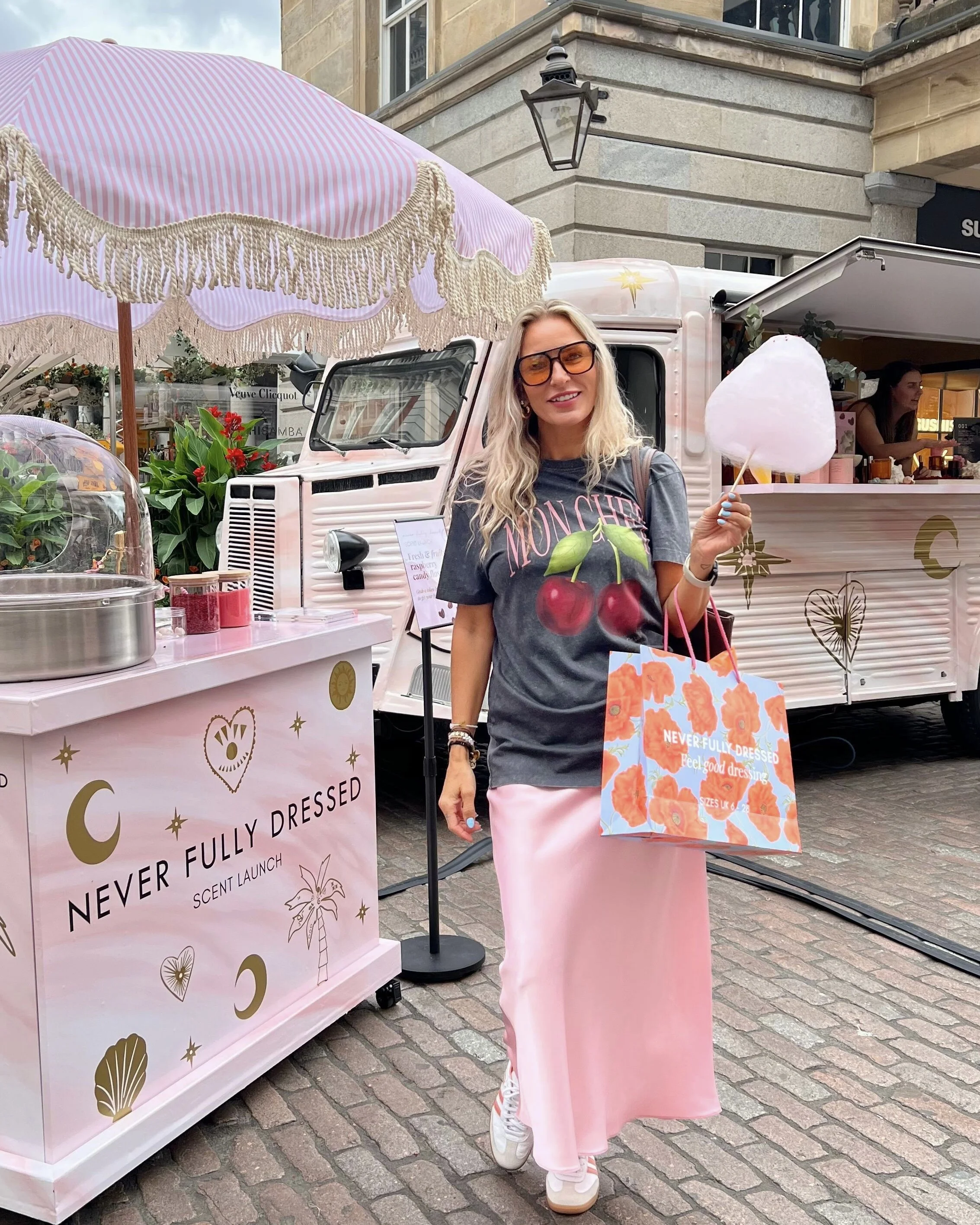 Guest enjoying candy floss at the Never Fully Dressed scent launch Covent Garden