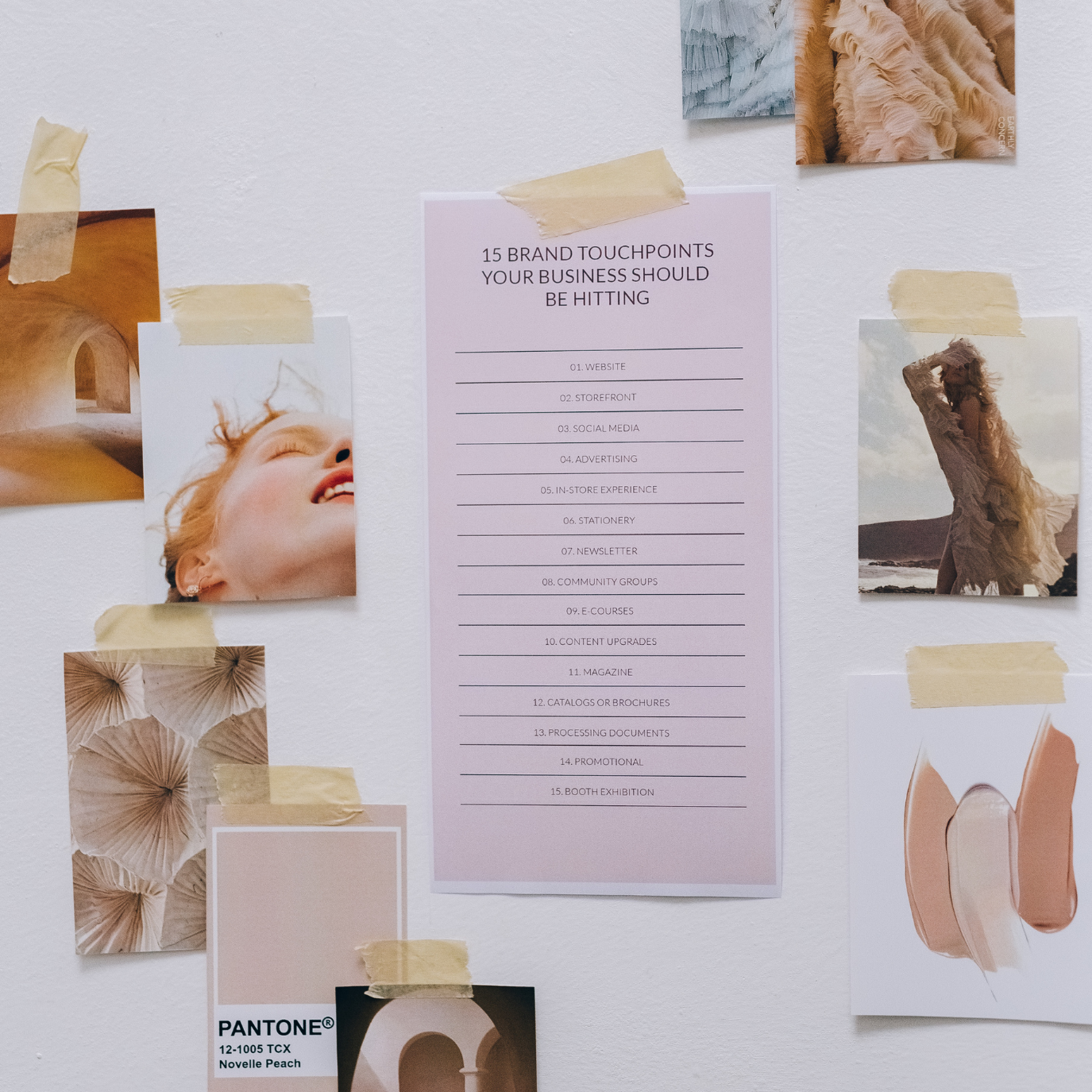A wall with various photographs, a pink sheet of paper listing 15 brand touchpoints, and notes taped around it. The photos include a close-up of a smiling woman with red hair, a woman in a beige dress on a beach, and abstract textures.