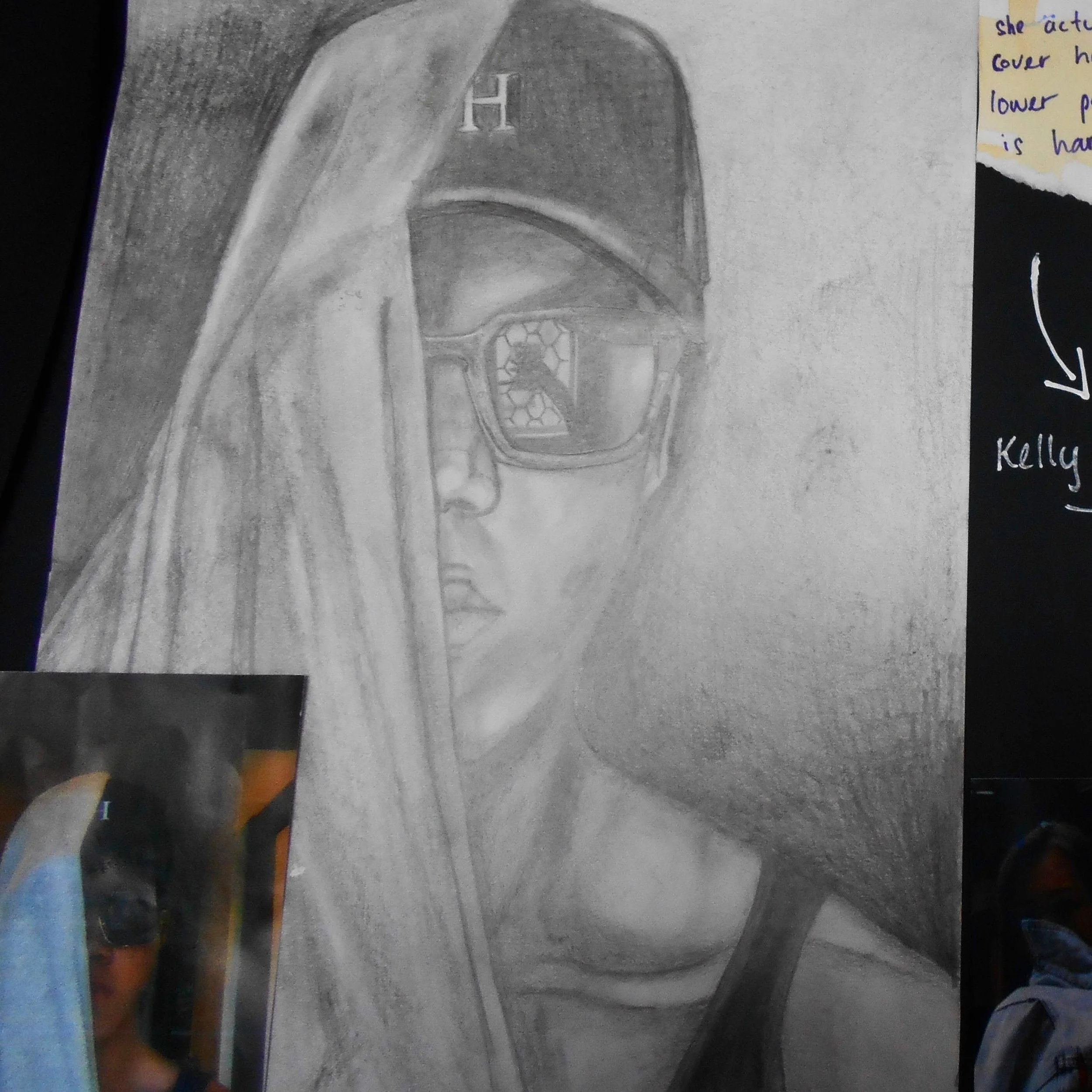 Pencil drawing of a woman wearing glasses, with a cloth covering her head over one eye, and a detailed reflection in the glasses showing geometric shapes.