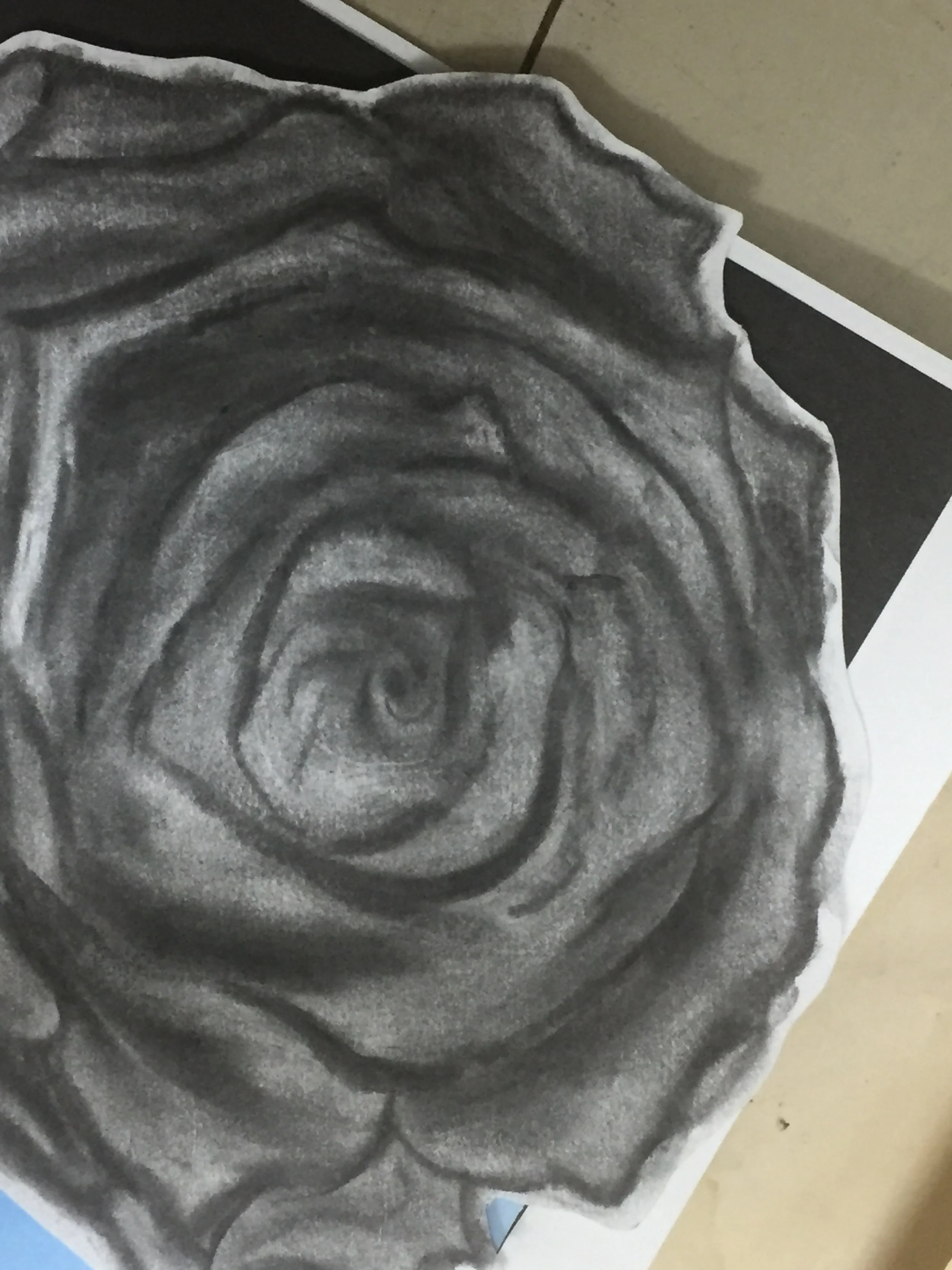 A black and white drawing of a rose flower.