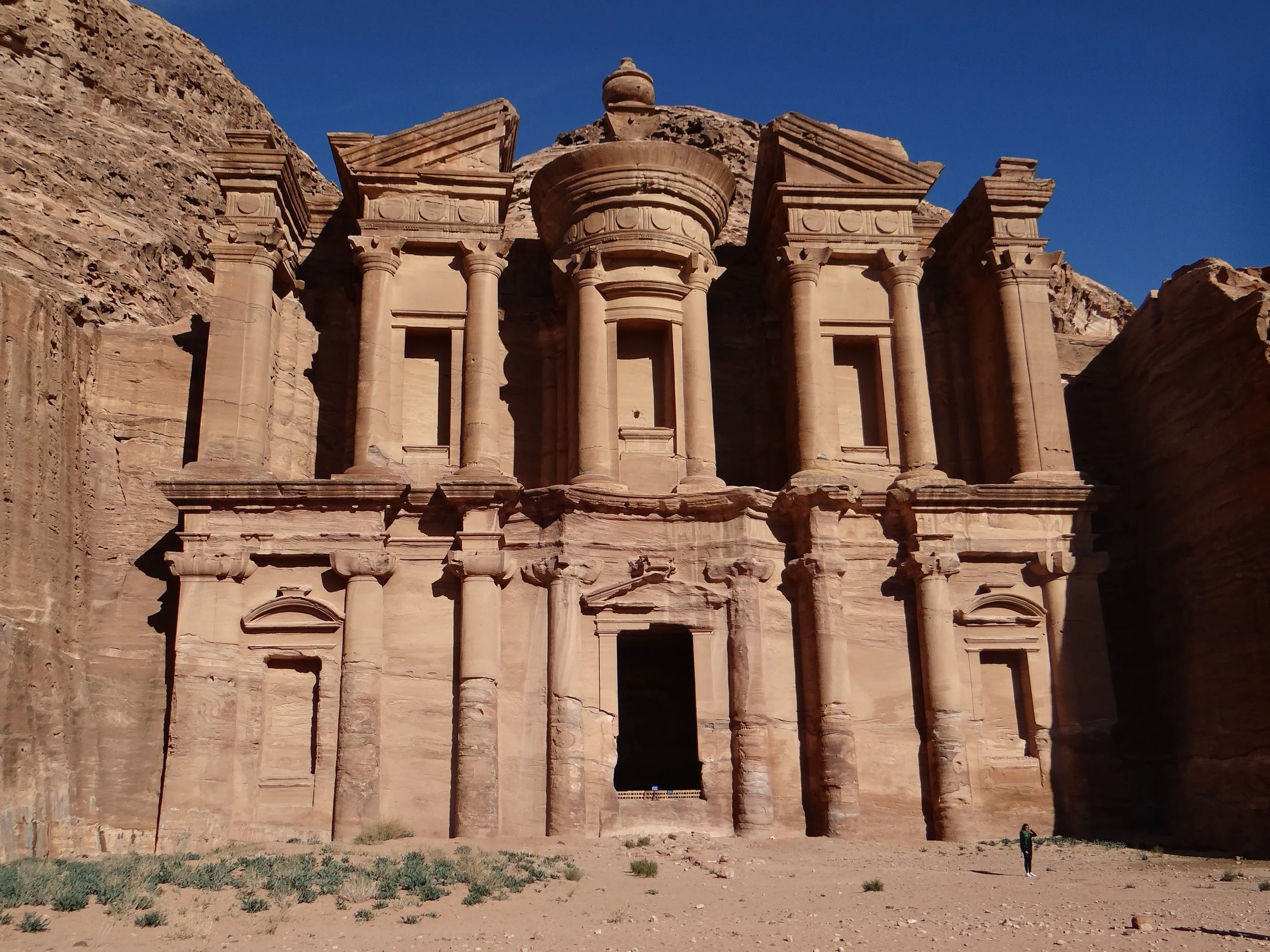 Ancient stone rock-cut facade with columns and intricate architecture, Petra, Jordan.