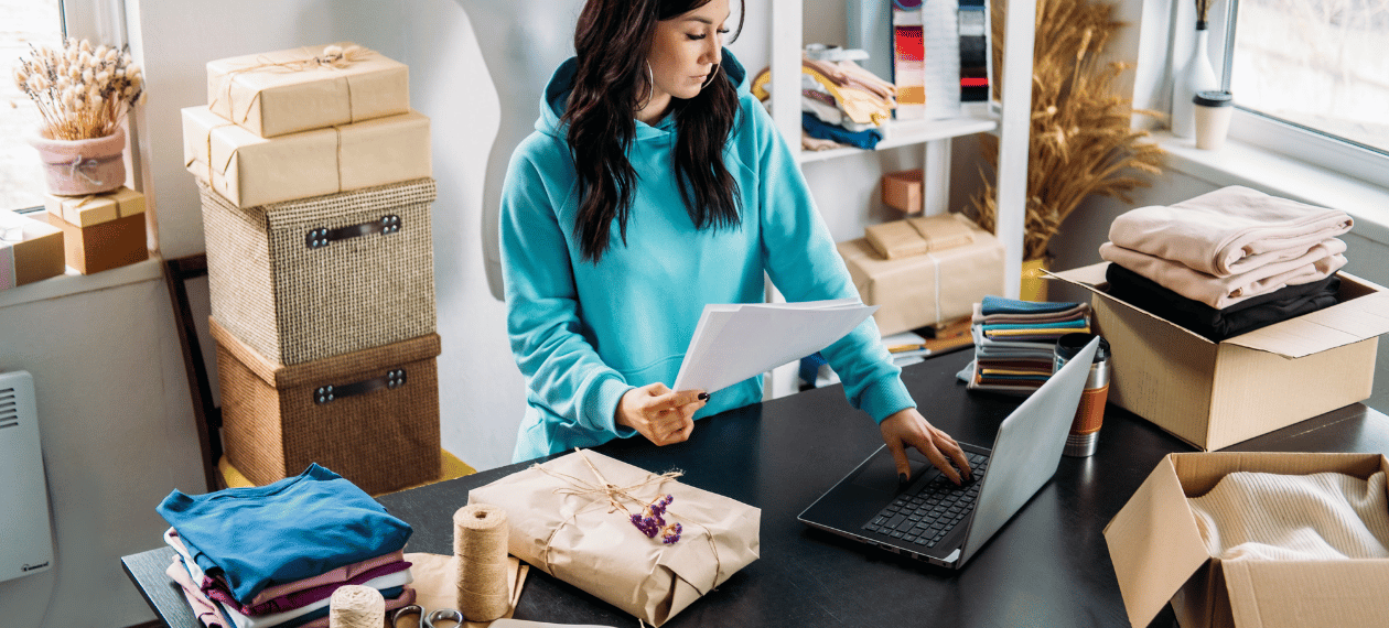 Small business owner reviewing inventory and business records in a retail shop
