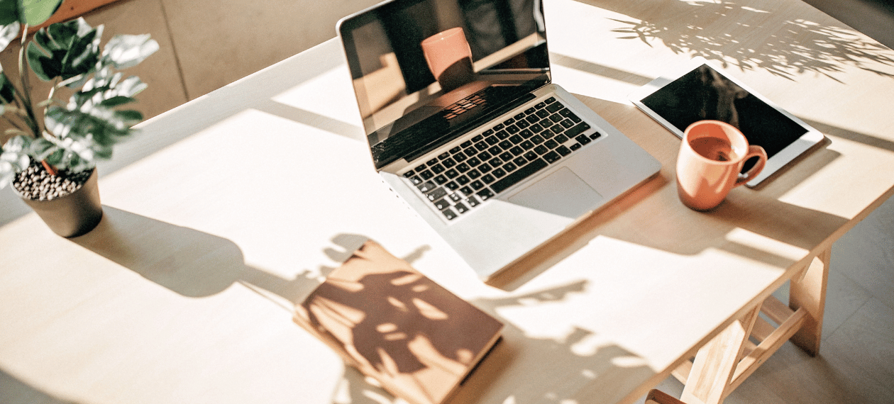 Laptop workspace used to manage a digital coaching business