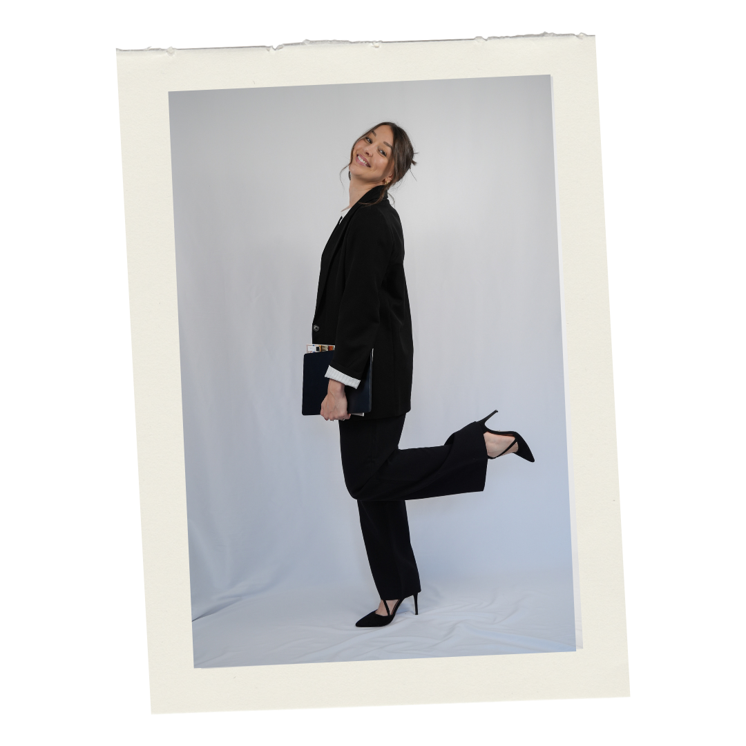 Hollie Griffiths smiling in a black suit with a playful pose, offering business consulting for small businesses
