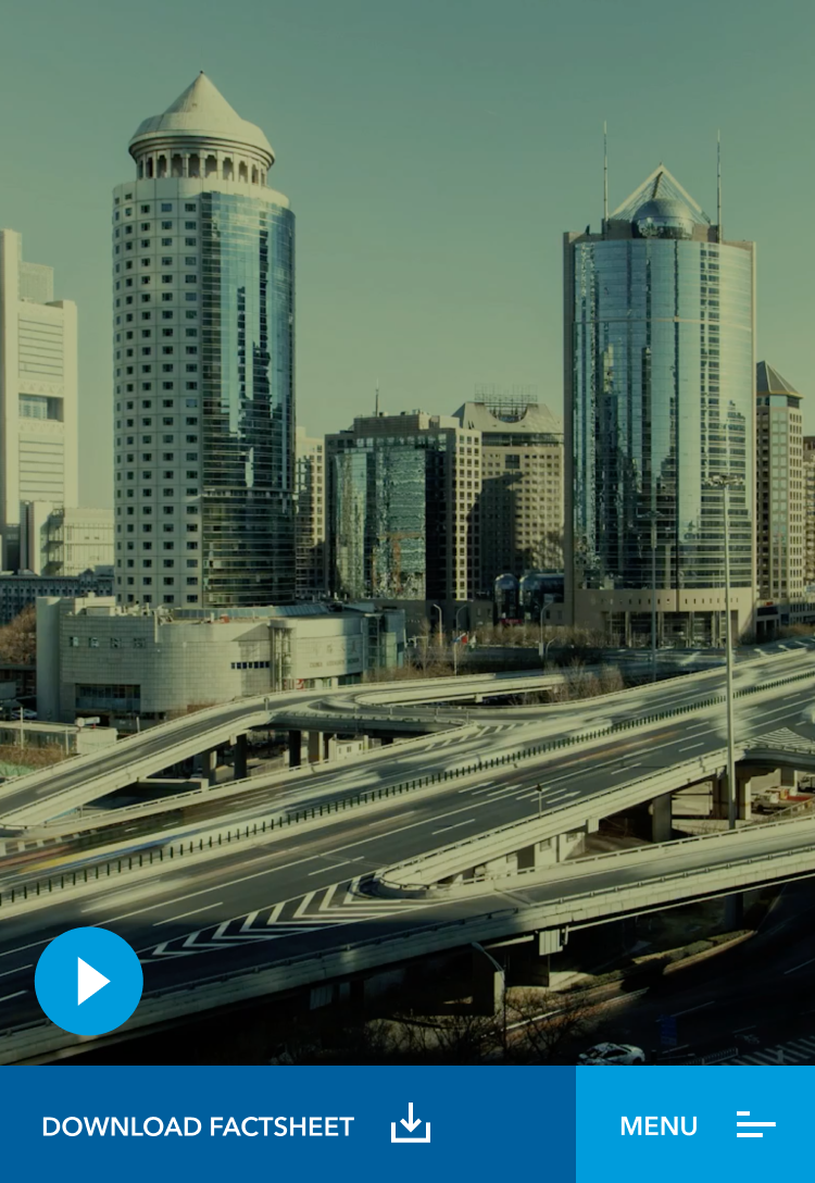 An urban landscape with skyscrapers and a multi-level highway system, with a play button overlay indicating a video about the fund's strategy is available, and a call-to-action button to download a factsheet.