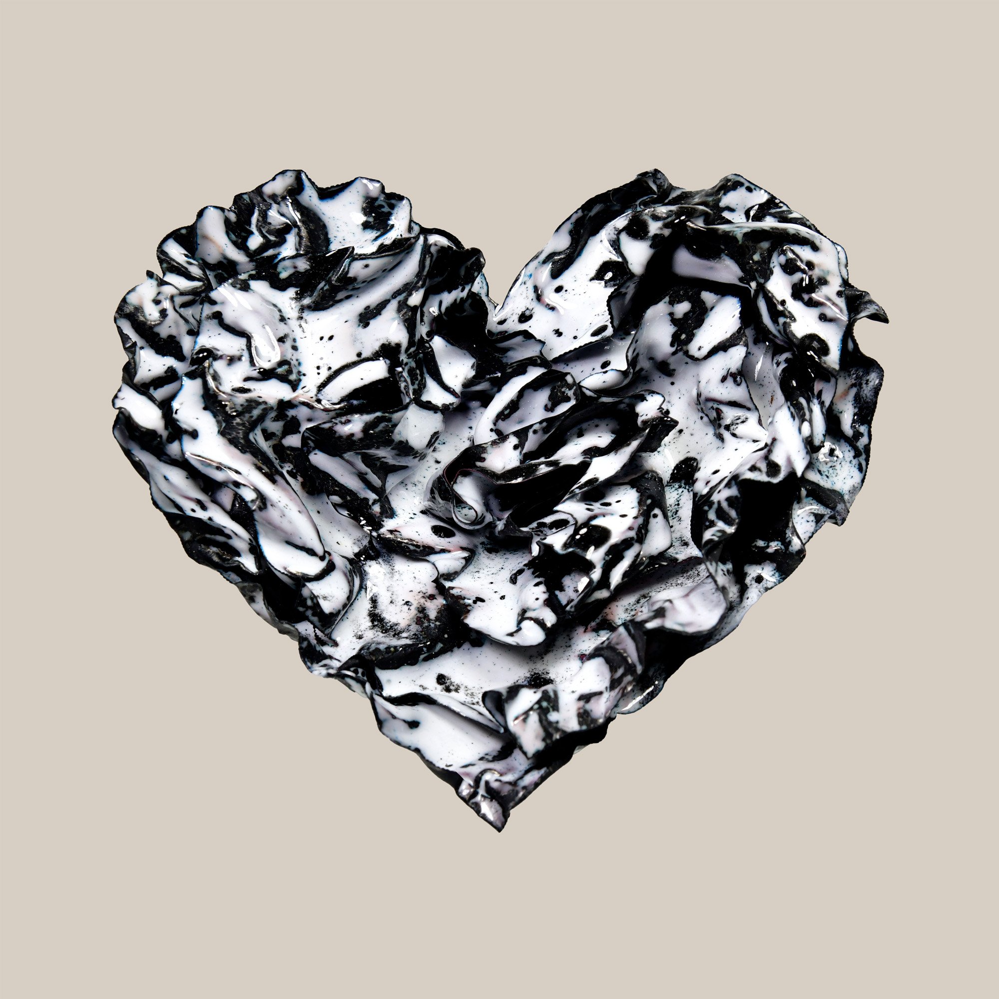 Black and white enamel heart sculpture titled “Still Ink” with glossy, marbled folds and fluid texture