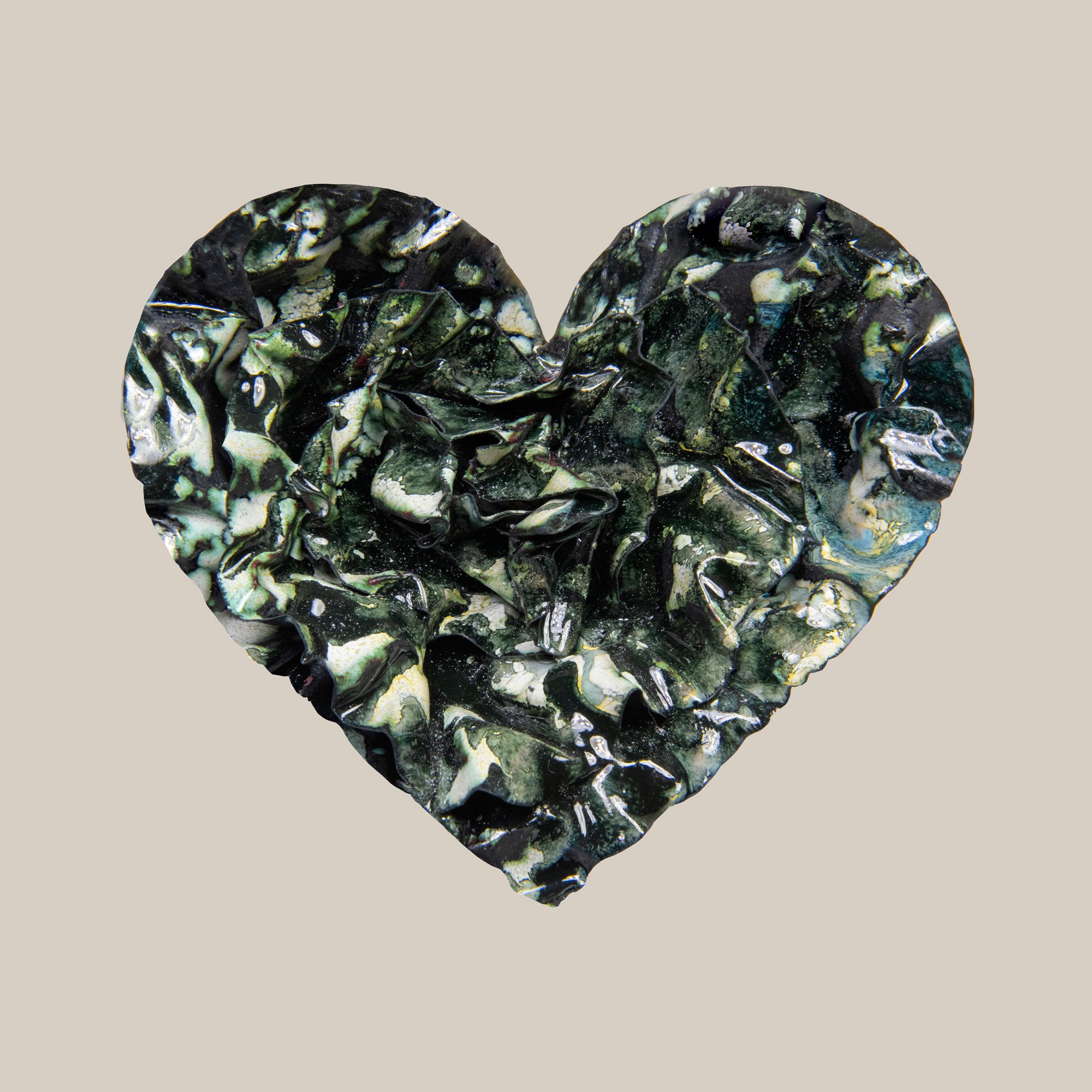 heart print in glossy black and dark green tones with textured, leaf-like folds and natural veining