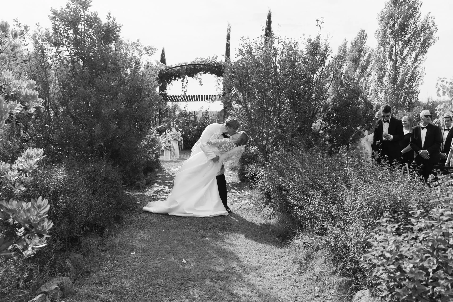 Spontaneous kiss of a happy couple right after saying 'I Do' at their Tuscan wedding.