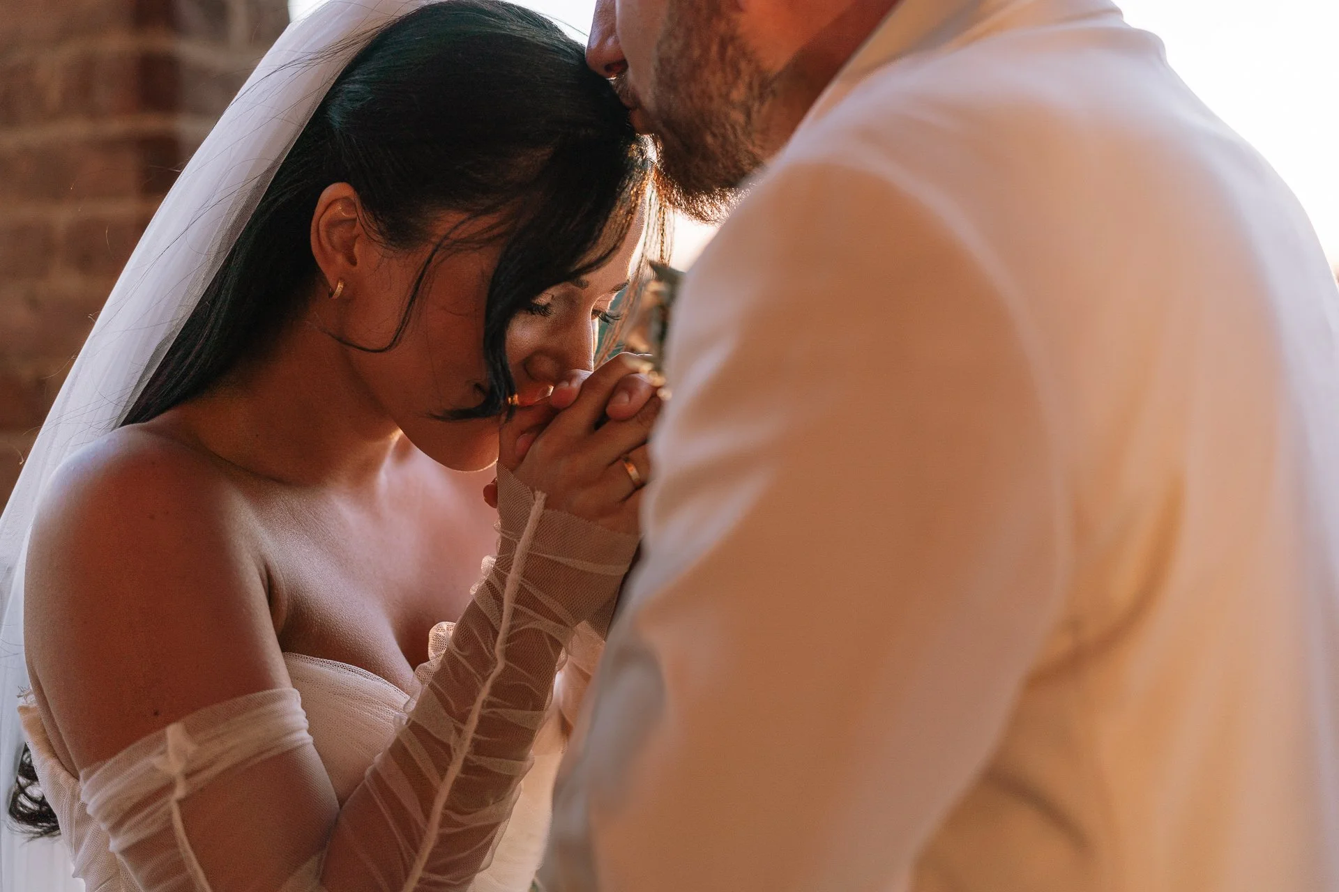 Bride and groom sharing a sweet moment during golden hour sunset at Villa Radi Siena.