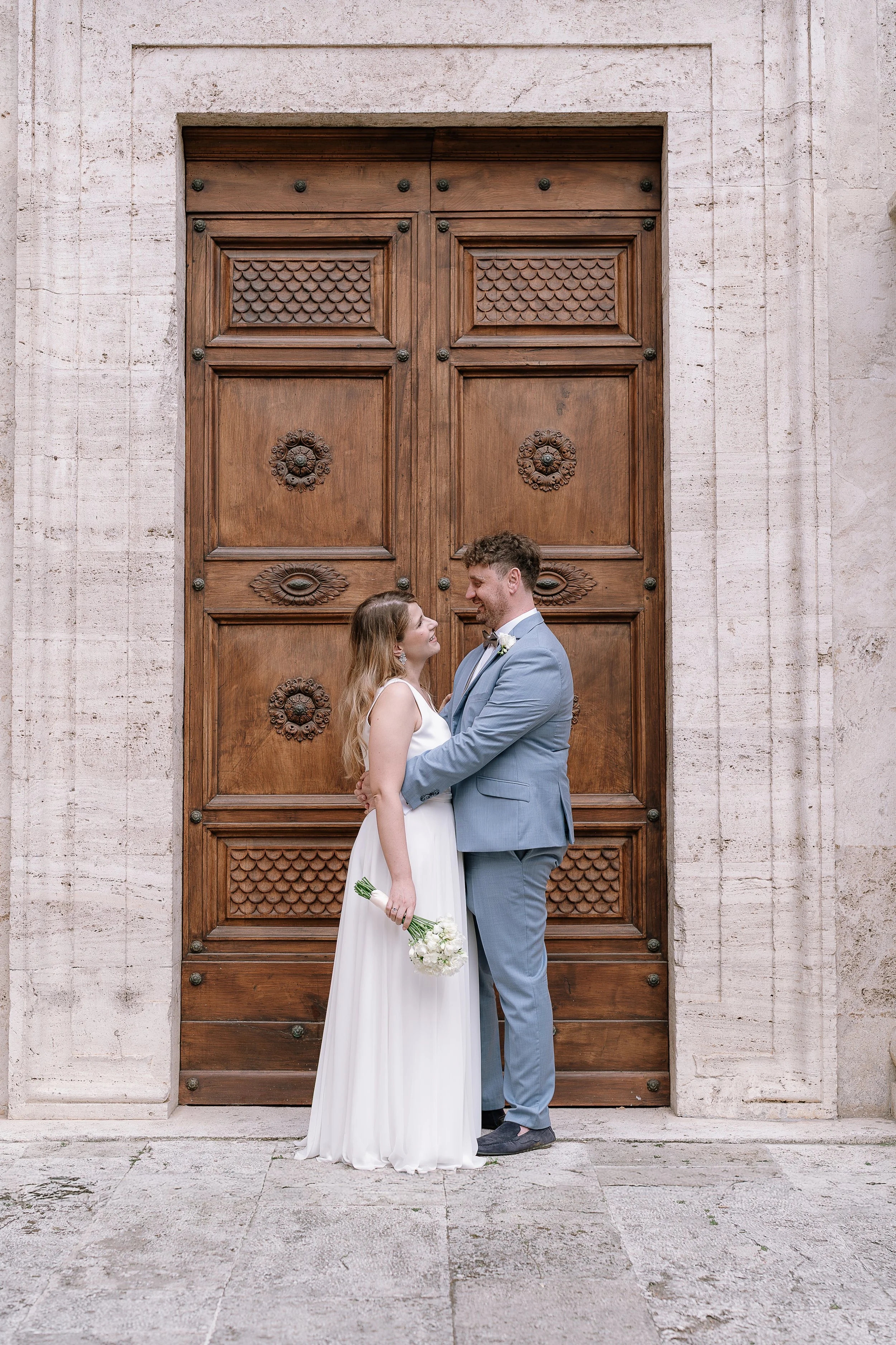 Authentic couple moment exploring the charming Renaissance streets of Pienza in Val d'Orcia.