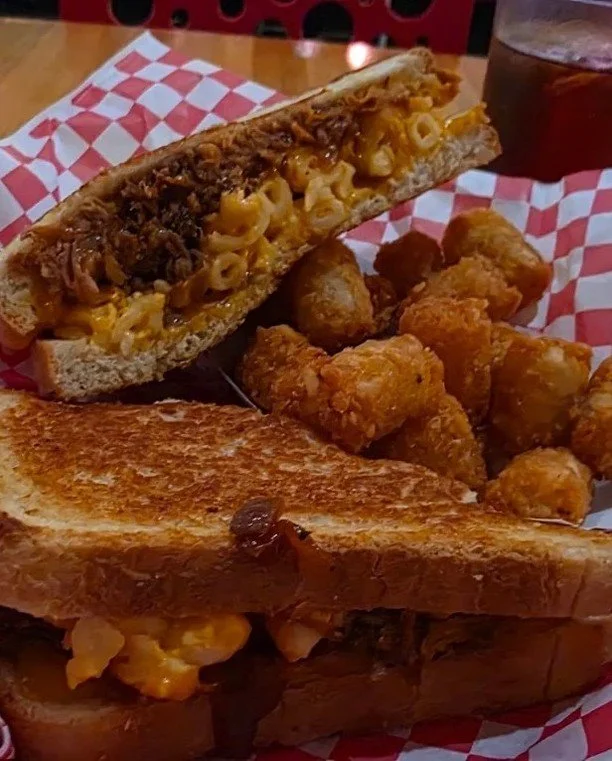 Southern Cookout vibes in melt form.
Pulled pork + mac &amp; cheese + melty cheese on grilled bread&hellip; with a side of tots, of course. This one&rsquo;s a legend for a reason.