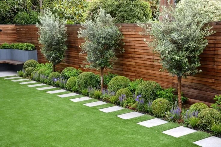 Well-maintained summer lawn in Toronto with trimmed edges and garden border