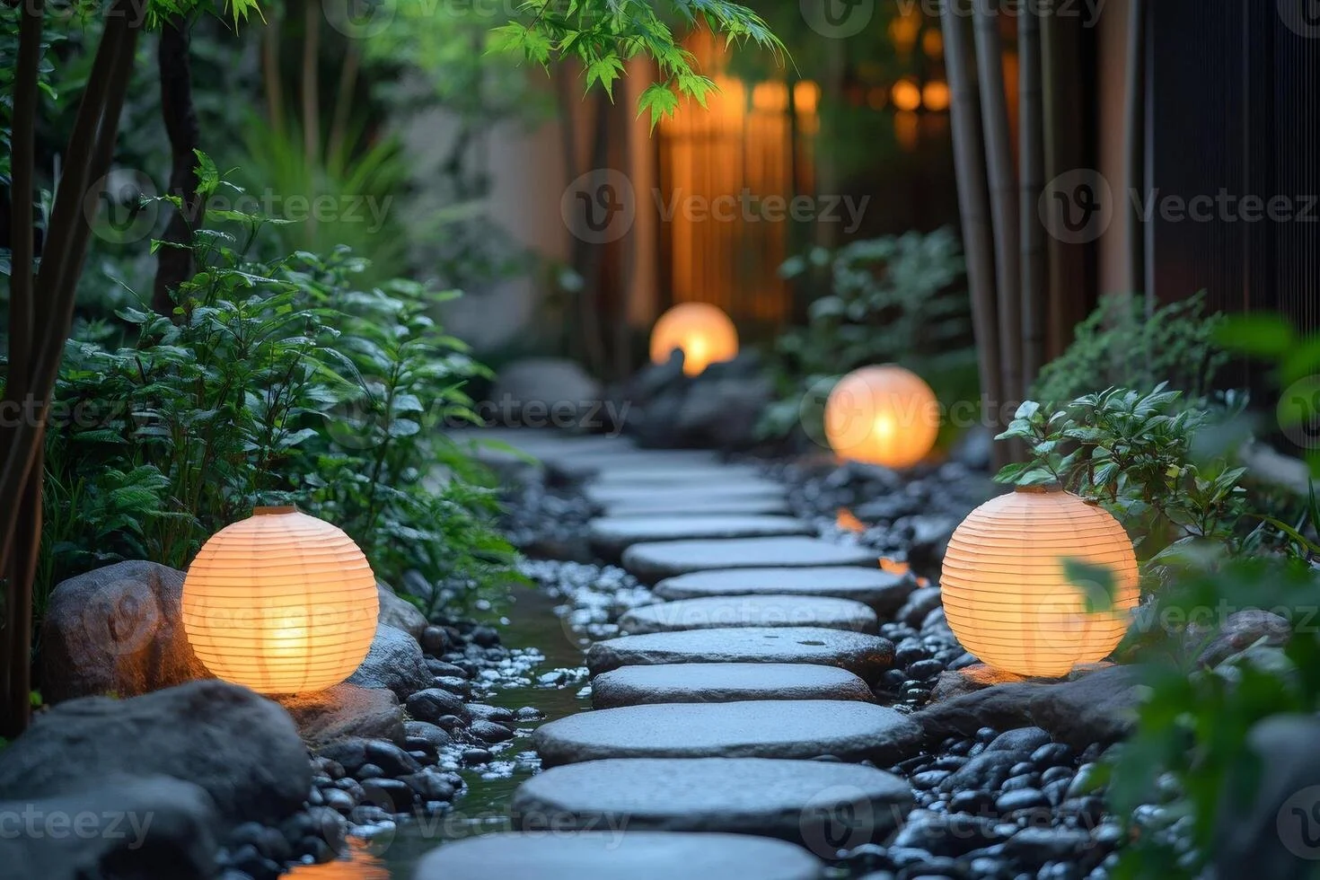 Garden pathway with round stone steps and glowing paper lanterns placed among greenery and rocks at night.