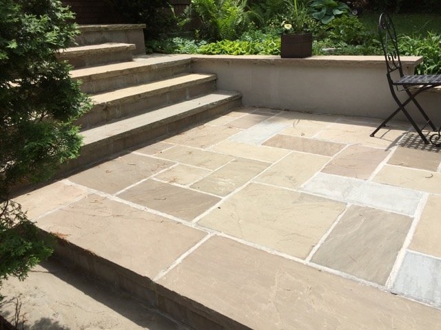 Natural stone steps and patio creating clean lines in a modern outdoor living space