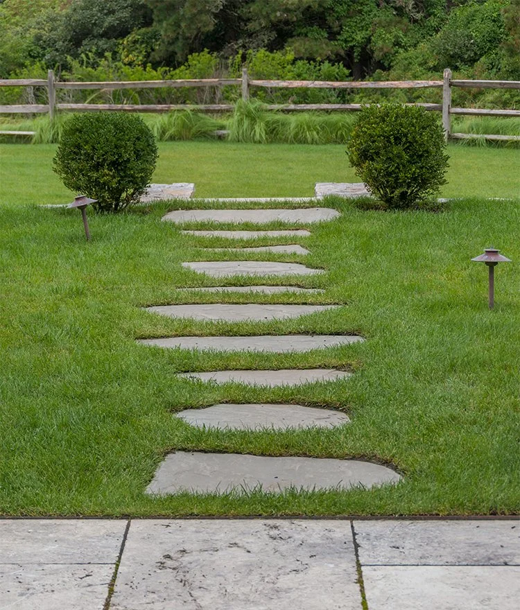 Modern stepping stone pathway set in green lawn for backyard garden access