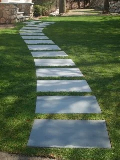 Stepping stone pathway set into lawn creating a natural garden walkway