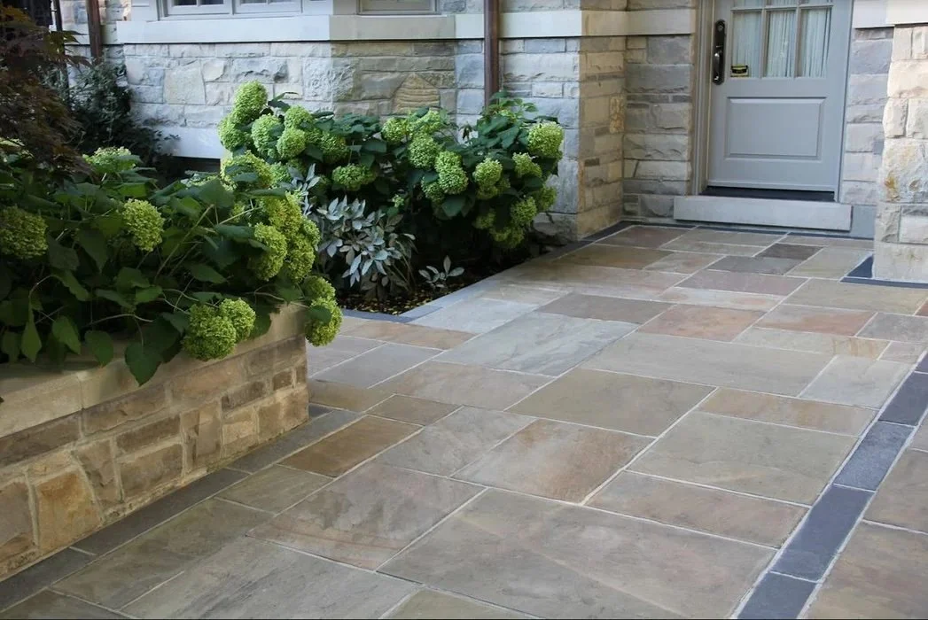 Front entry stone walkway with planting beds and natural stone pavers
