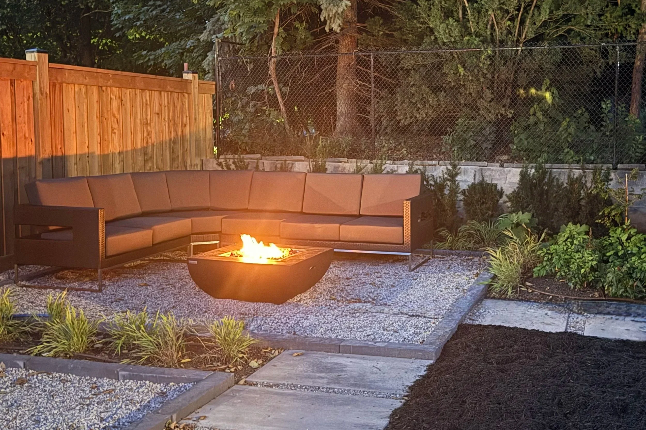 backyard landscape with fire pit and gardens
