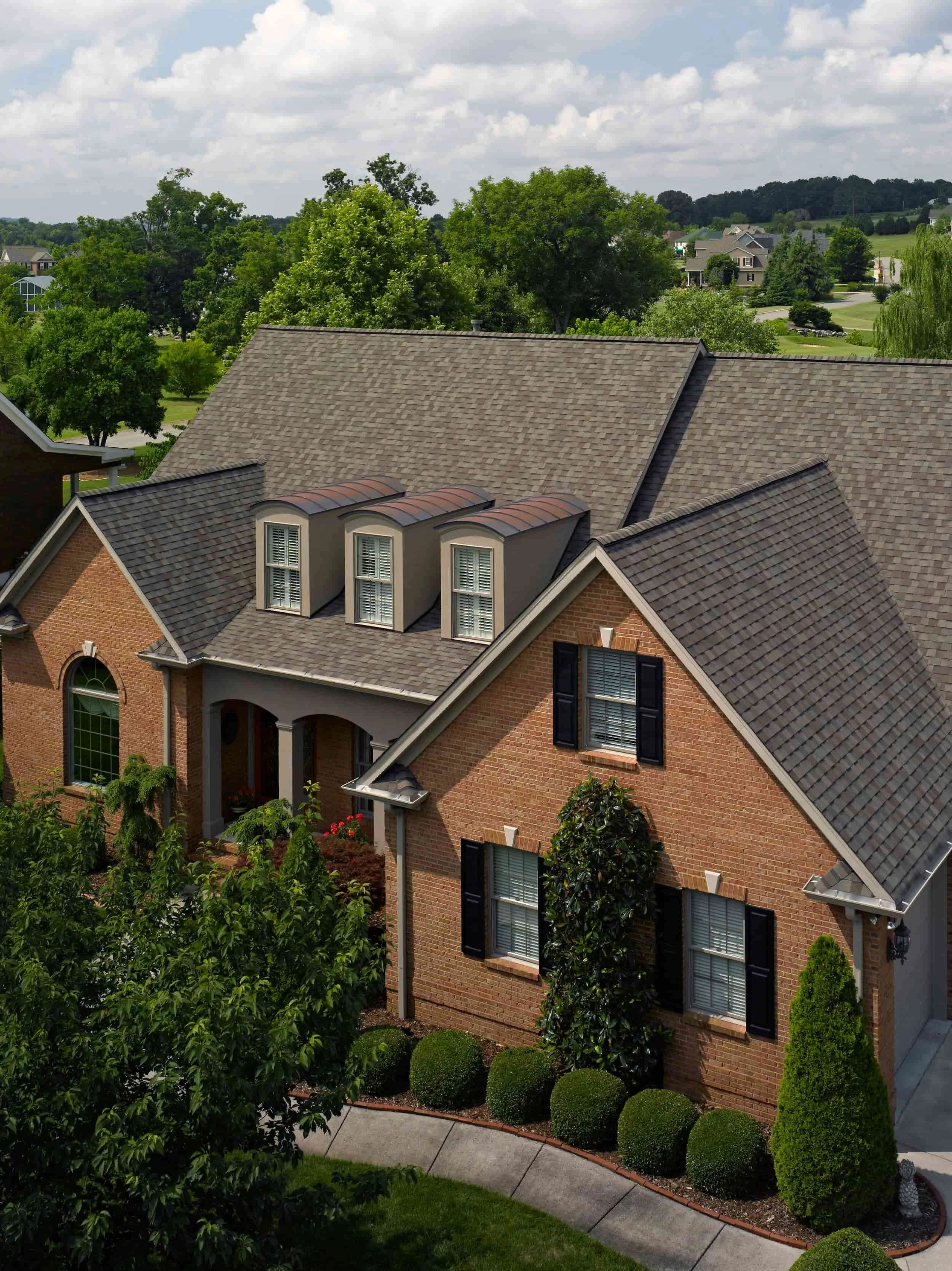 CertainTeed Landmark PRO roof installation on large two-story home with manicured lawn