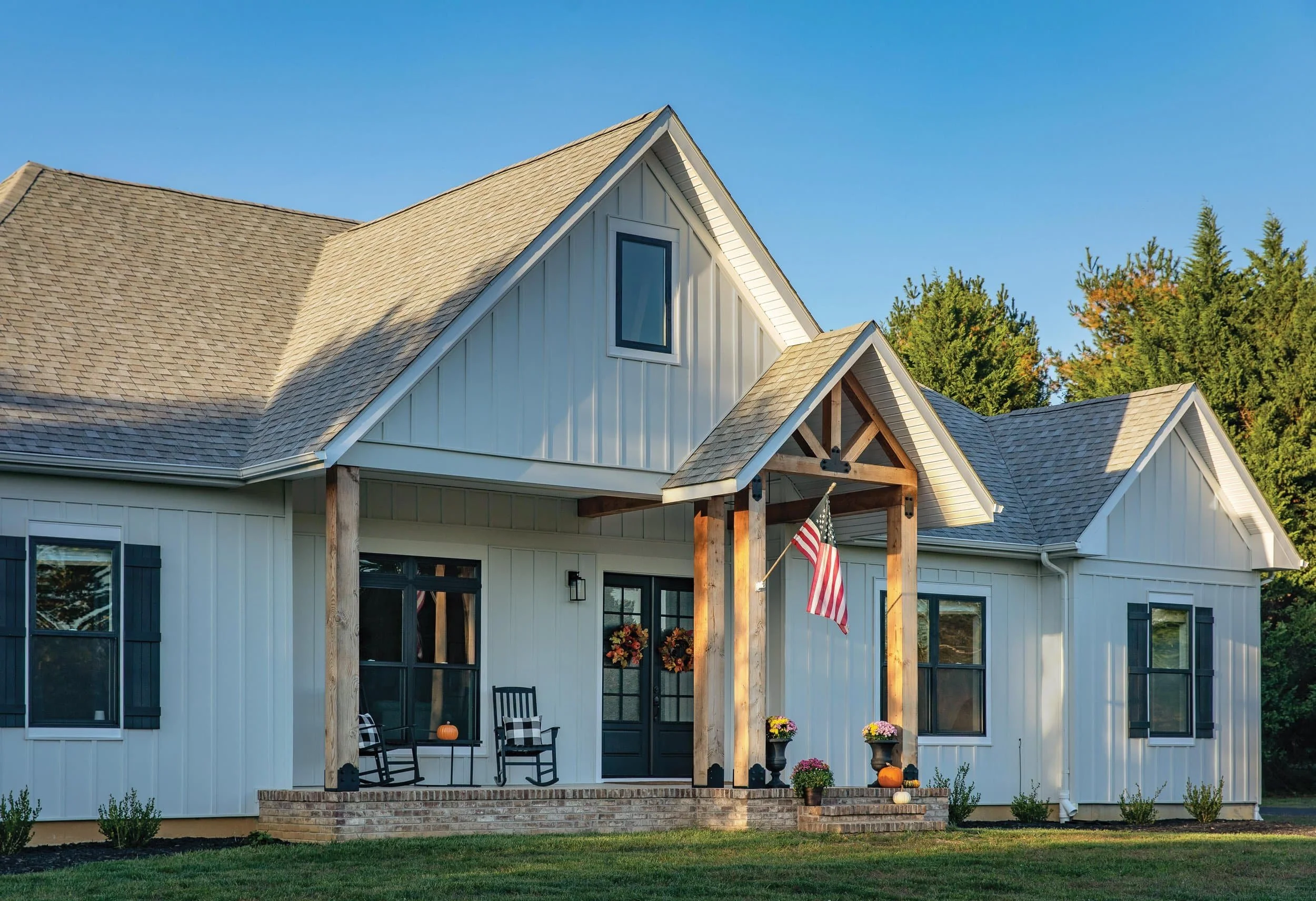 Home exterior with James Hardie Arctic White board and batten siding and black window trim