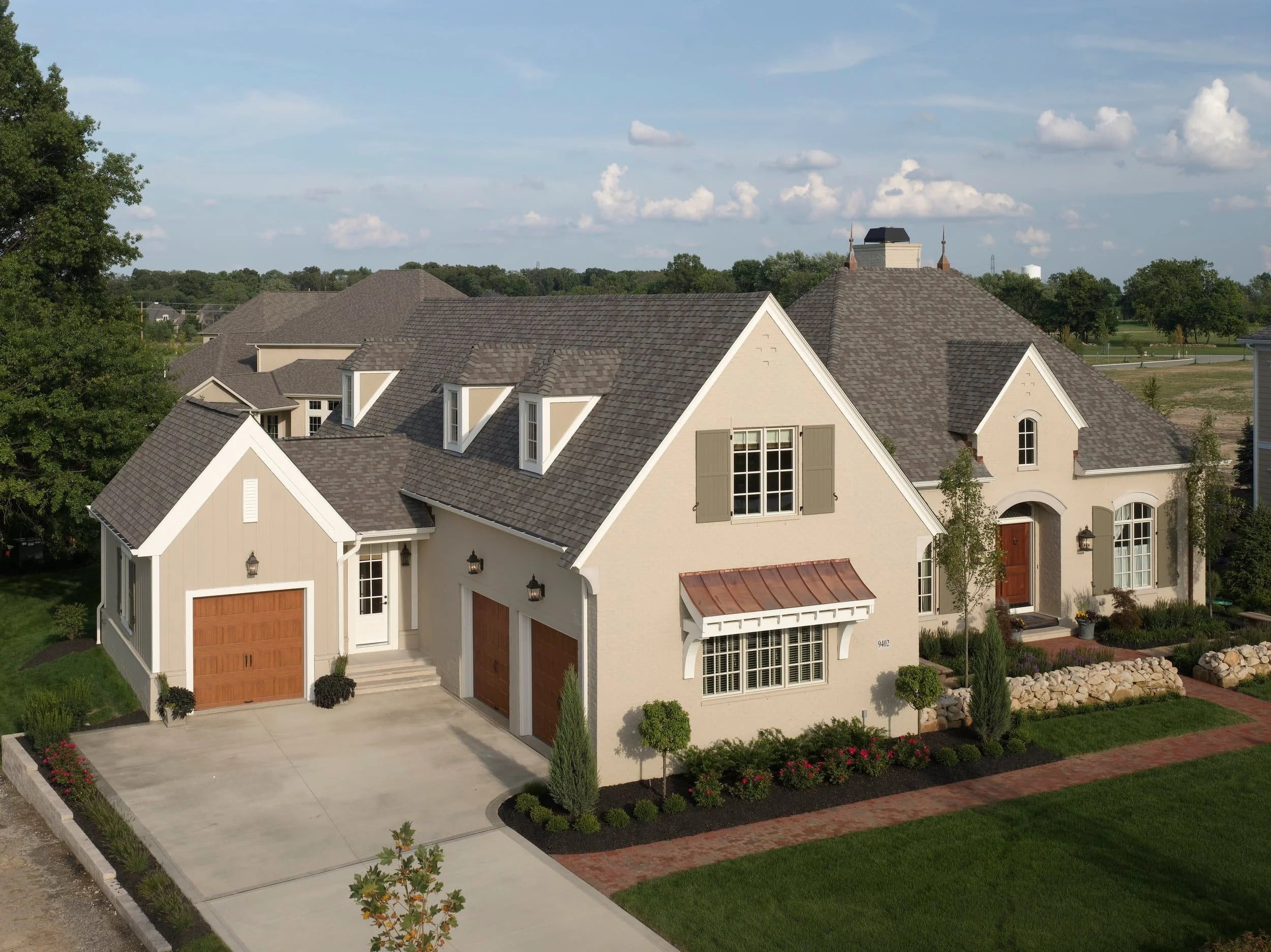 CertainTeed Landmark PRO shingles on brick two-story home with mature trees in Metro Detroit