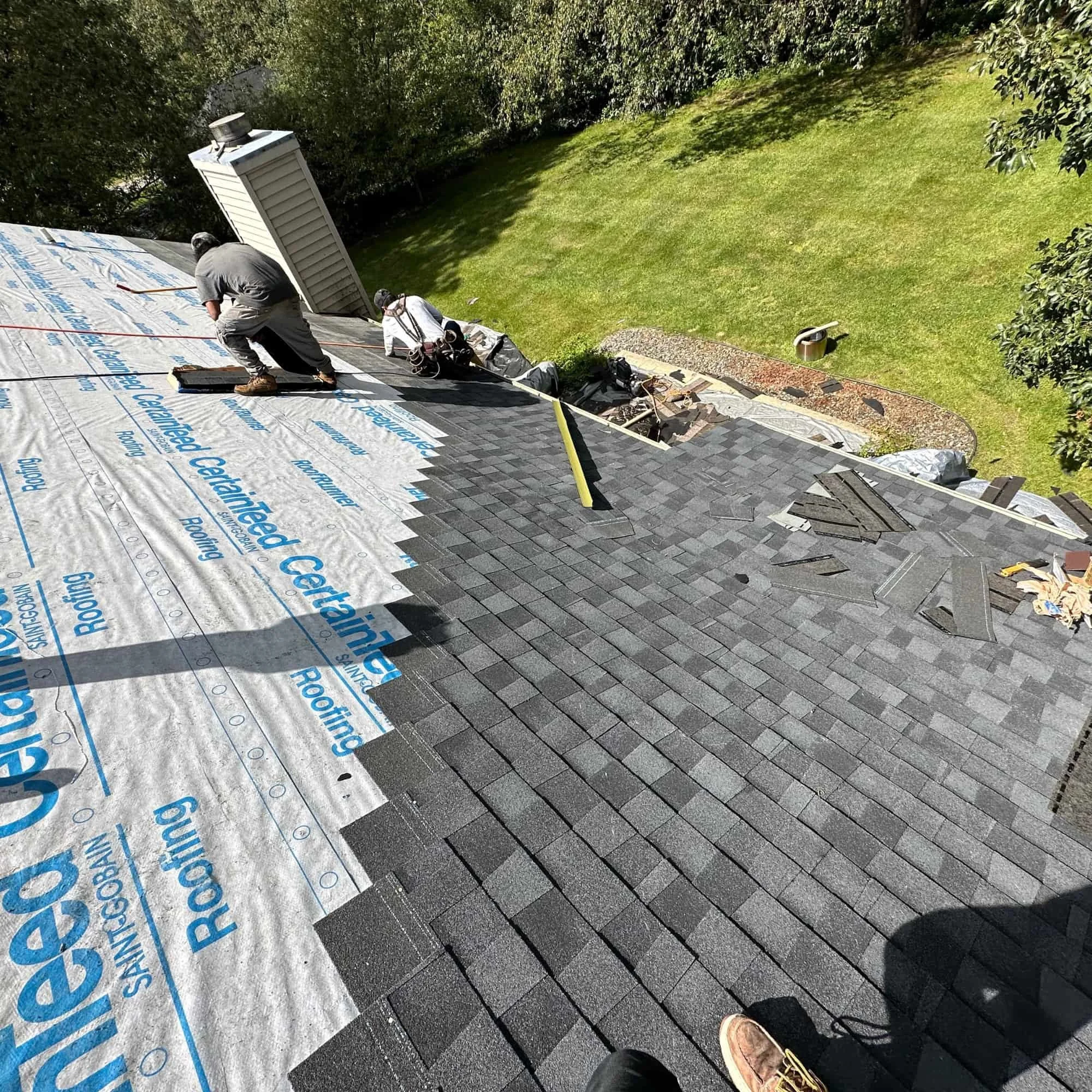Roof valley showing granule loss and surface cracking on deteriorating asphalt shingles