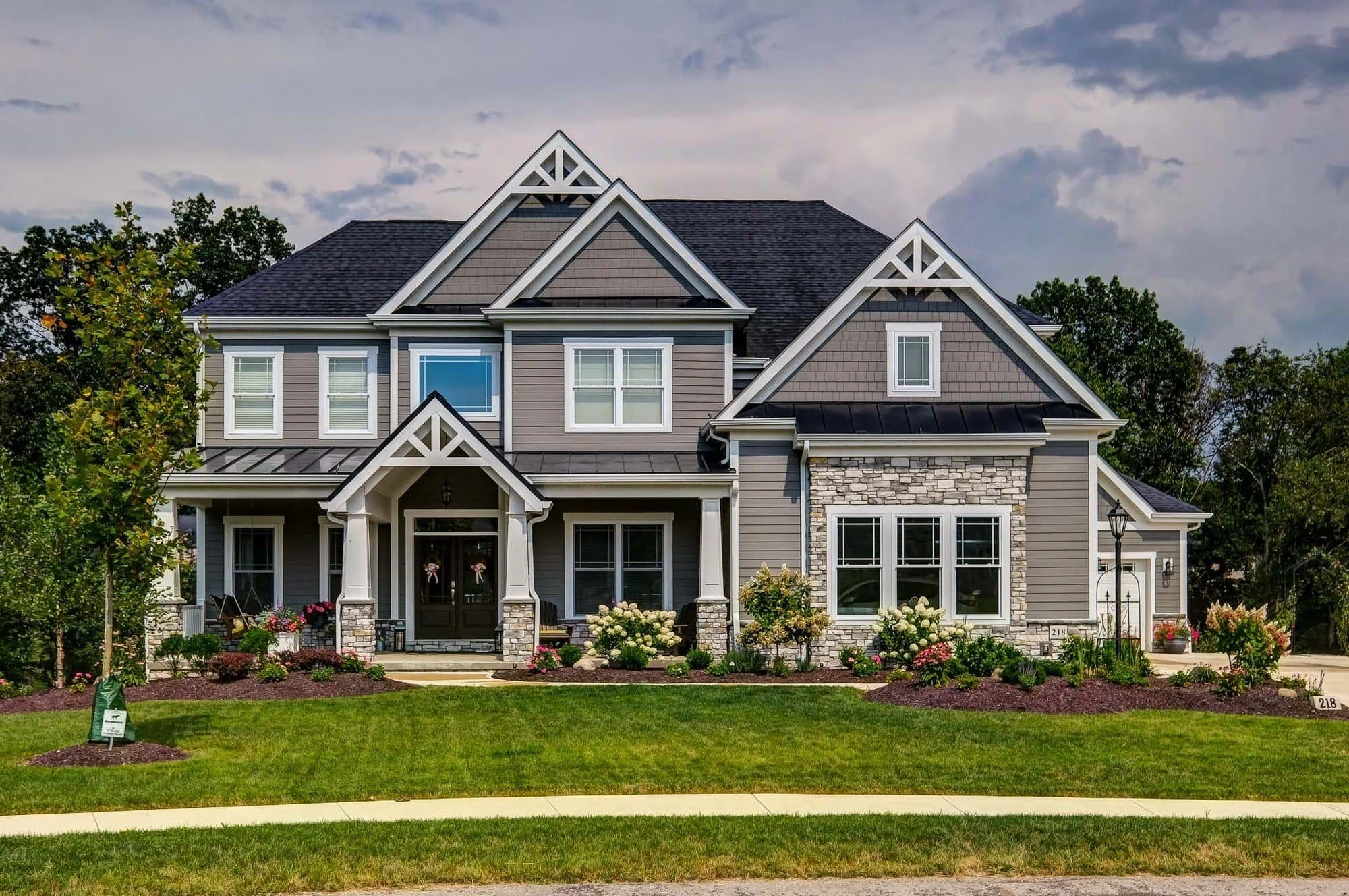 Large suburban home with James Hardie lap siding in warm neutral tones and traditional architecture