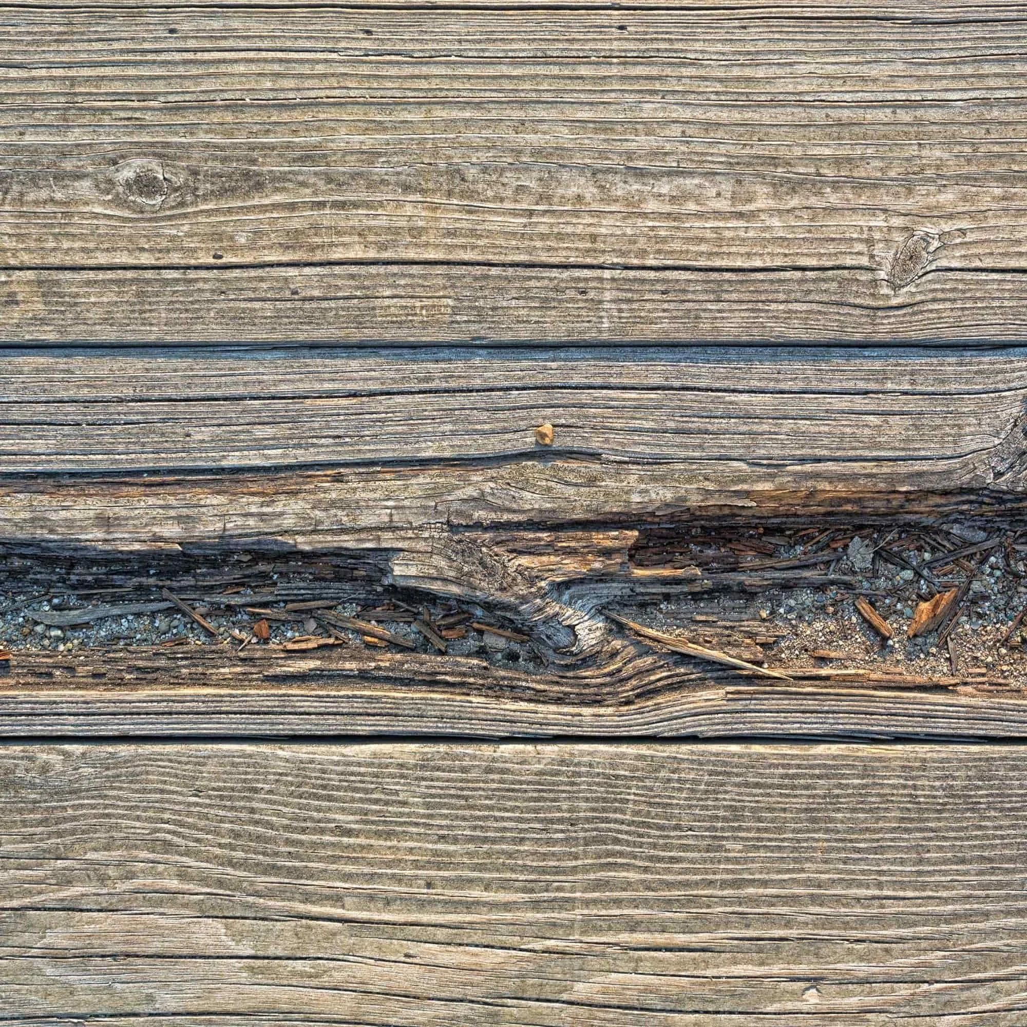 Close-up of weathered wooden planks with cracks and visible textures.