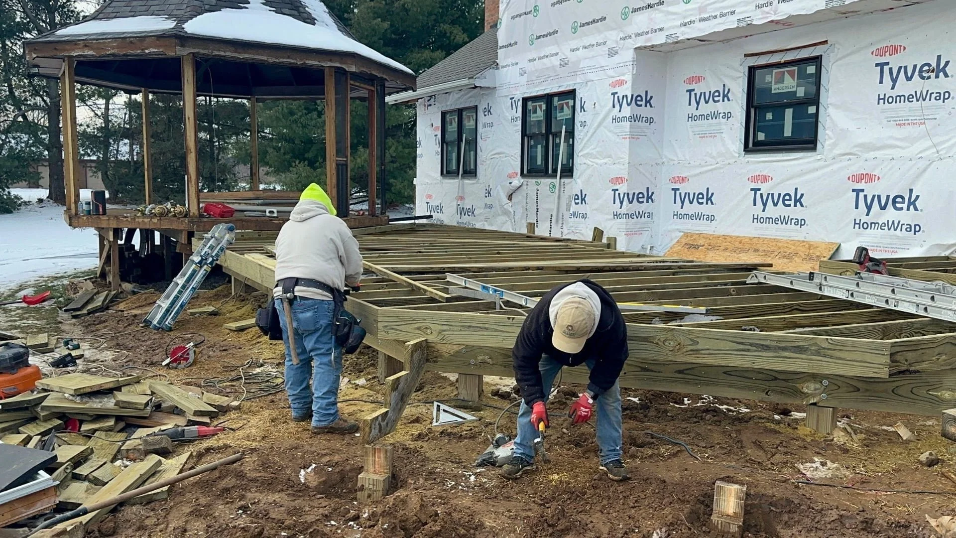 Allied Siding and Roofing contractor reviewing project details with homeowner on job site