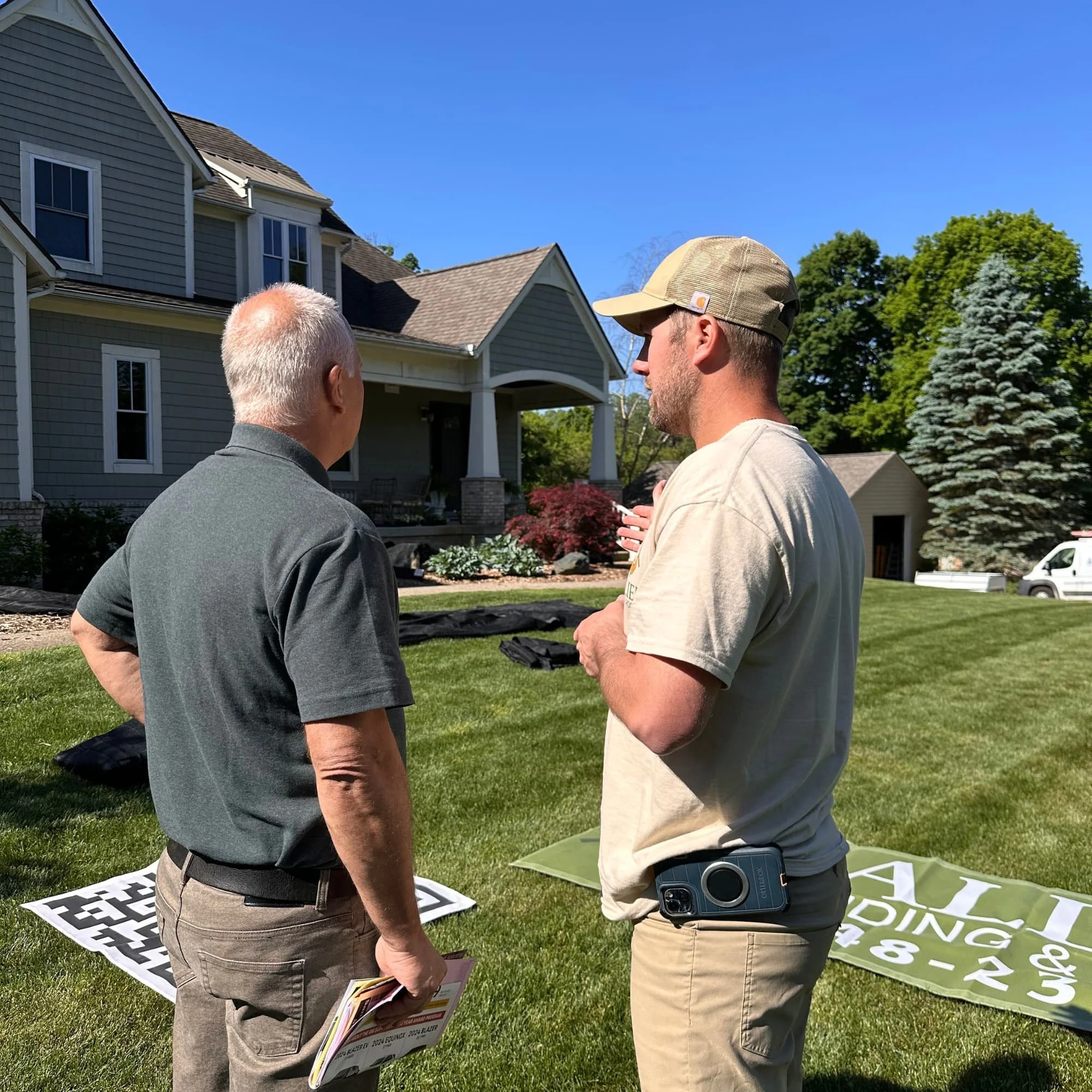 Allied Siding and Roofing crew installing new roofing materials on residential home