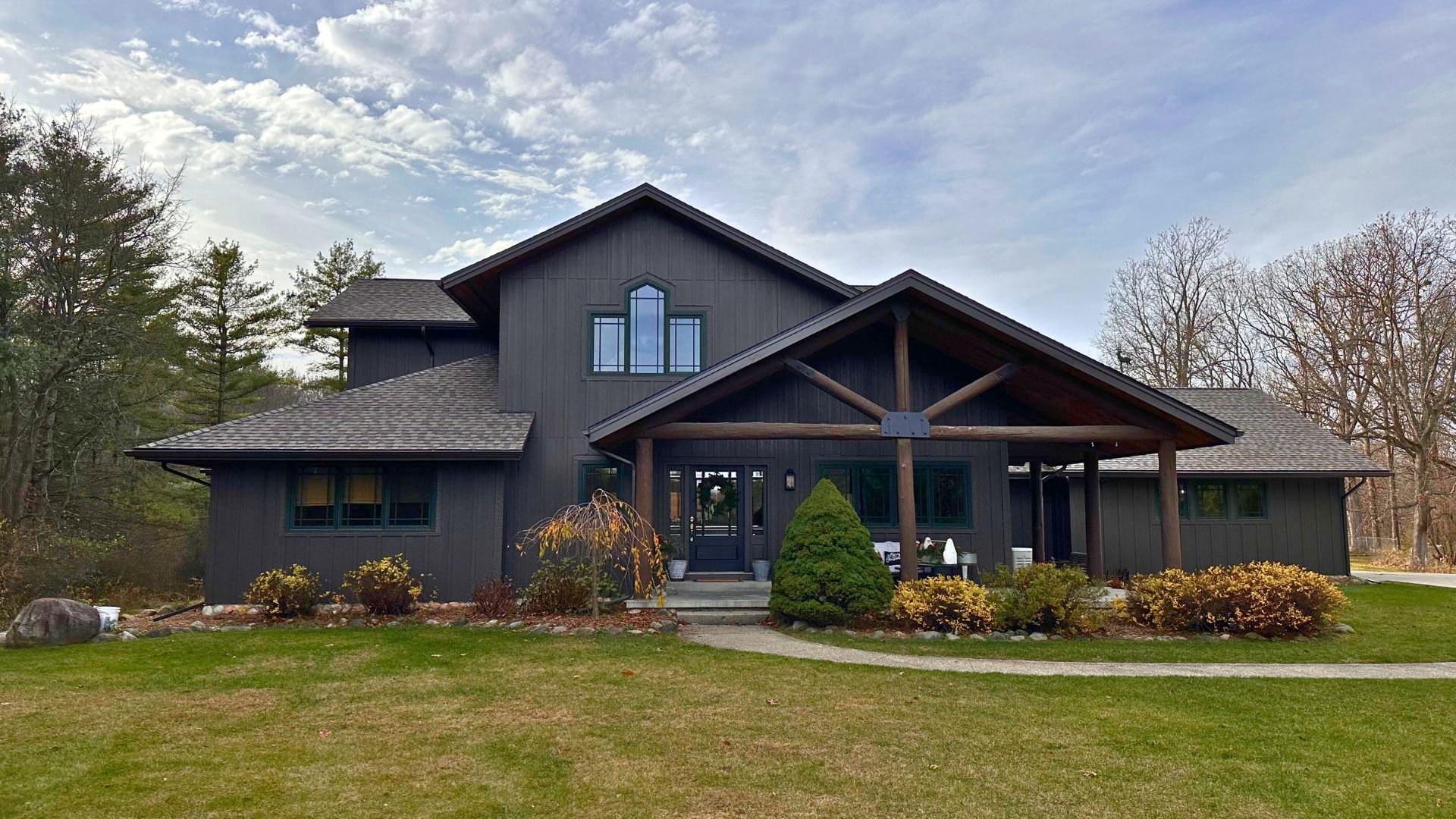 Ranch home with aging wood siding showing faded paint and worn exterior finish