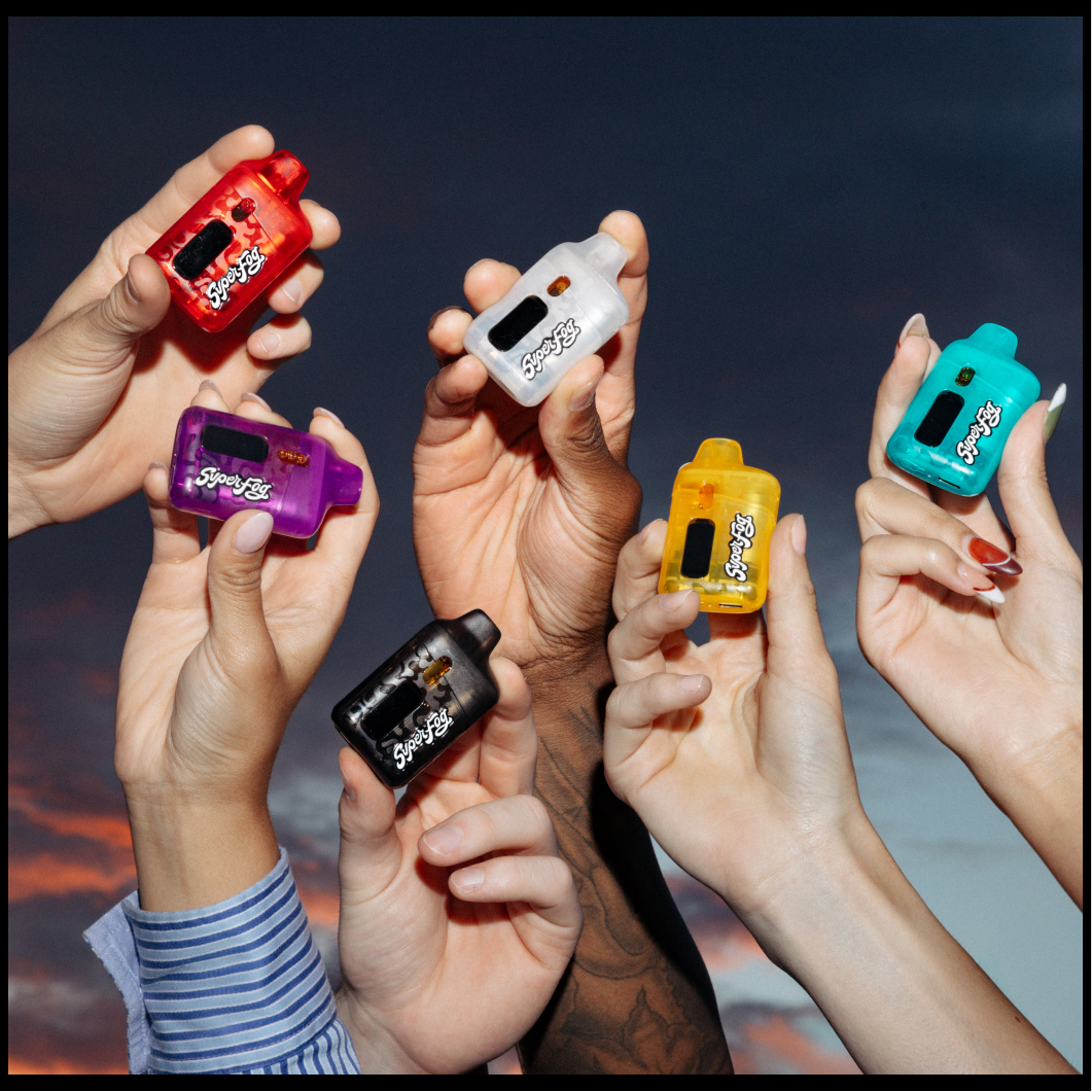 Multiple hands holding colorful mini electronic devices against a cloudy sky background.