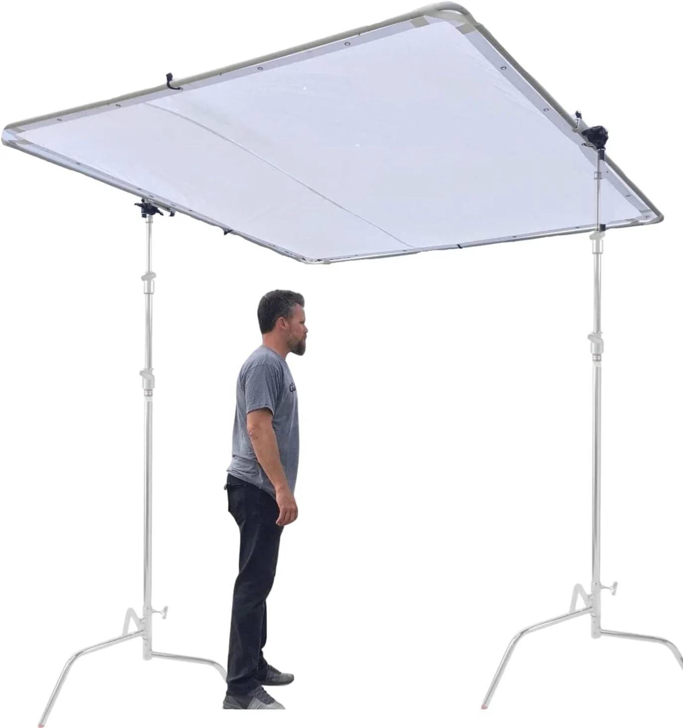 A large, rectangular overhead diffusion frame with a person standing beneath it demonstrates its size.