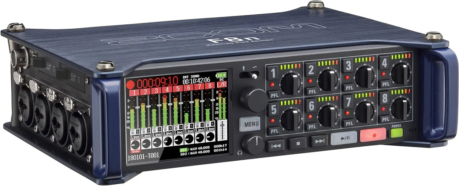 A black multi-channel audio recorder with various inputs and controls is shown from the front.