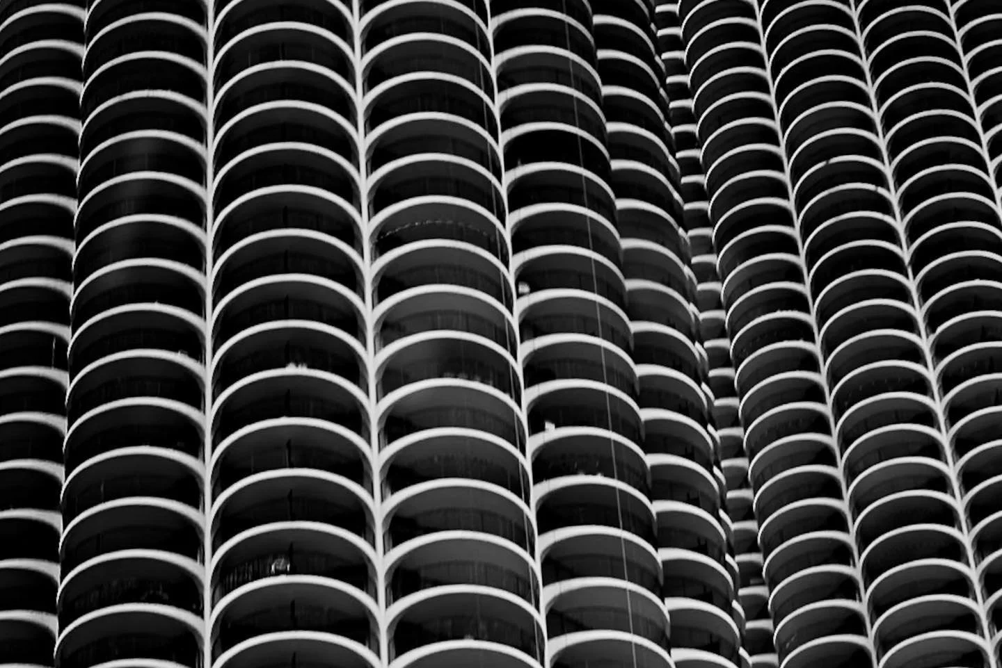 Chicago&rsquo;s iconic Marina City, captured in black and white, transforms into a mesmerizing abstraction in this frame. The repeating curves and stark contrasts of light and shadow invite you to lose yourself in the hypnotic rhythm of the architect