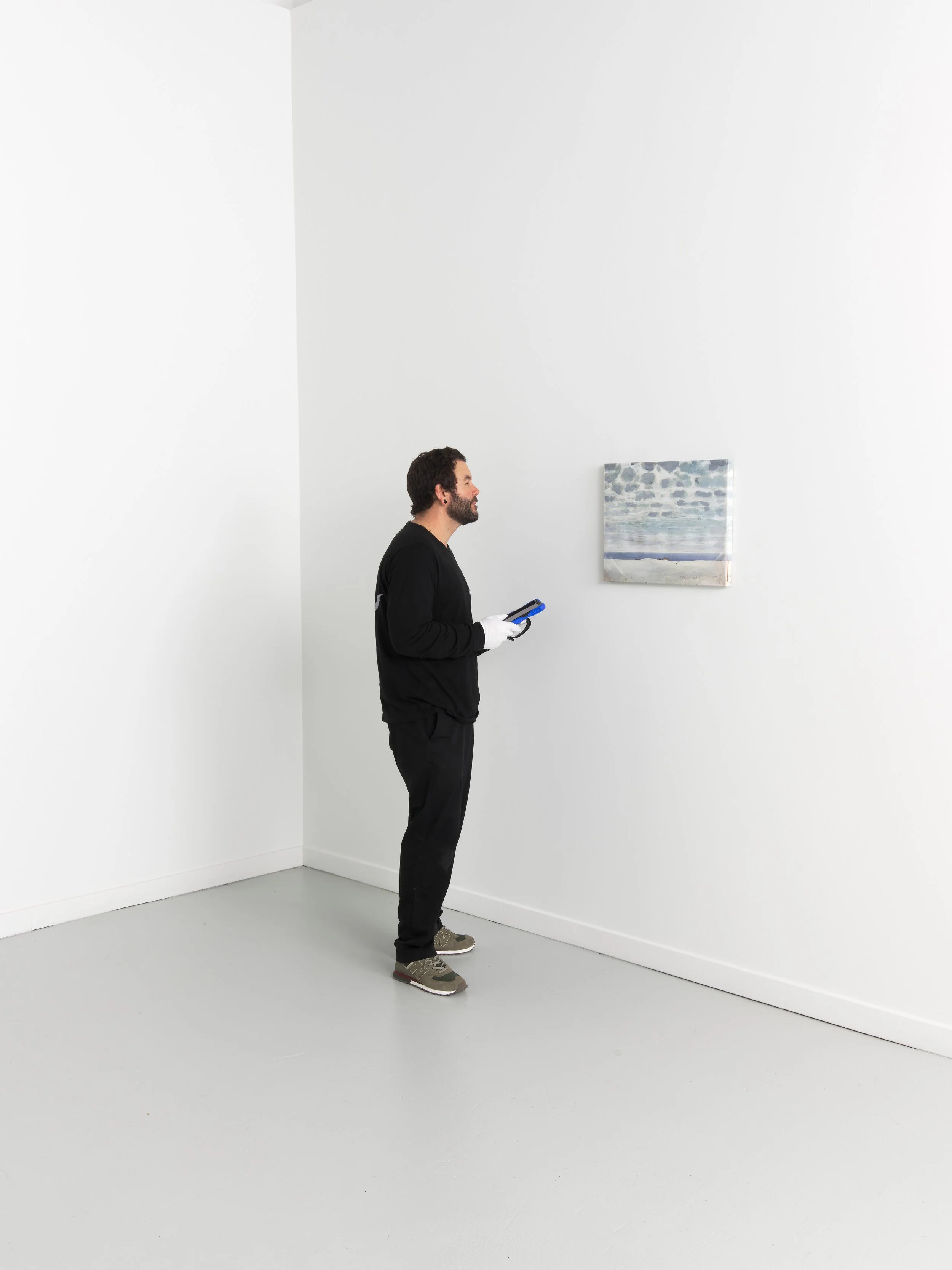 a man in a viewing room holding an ipad