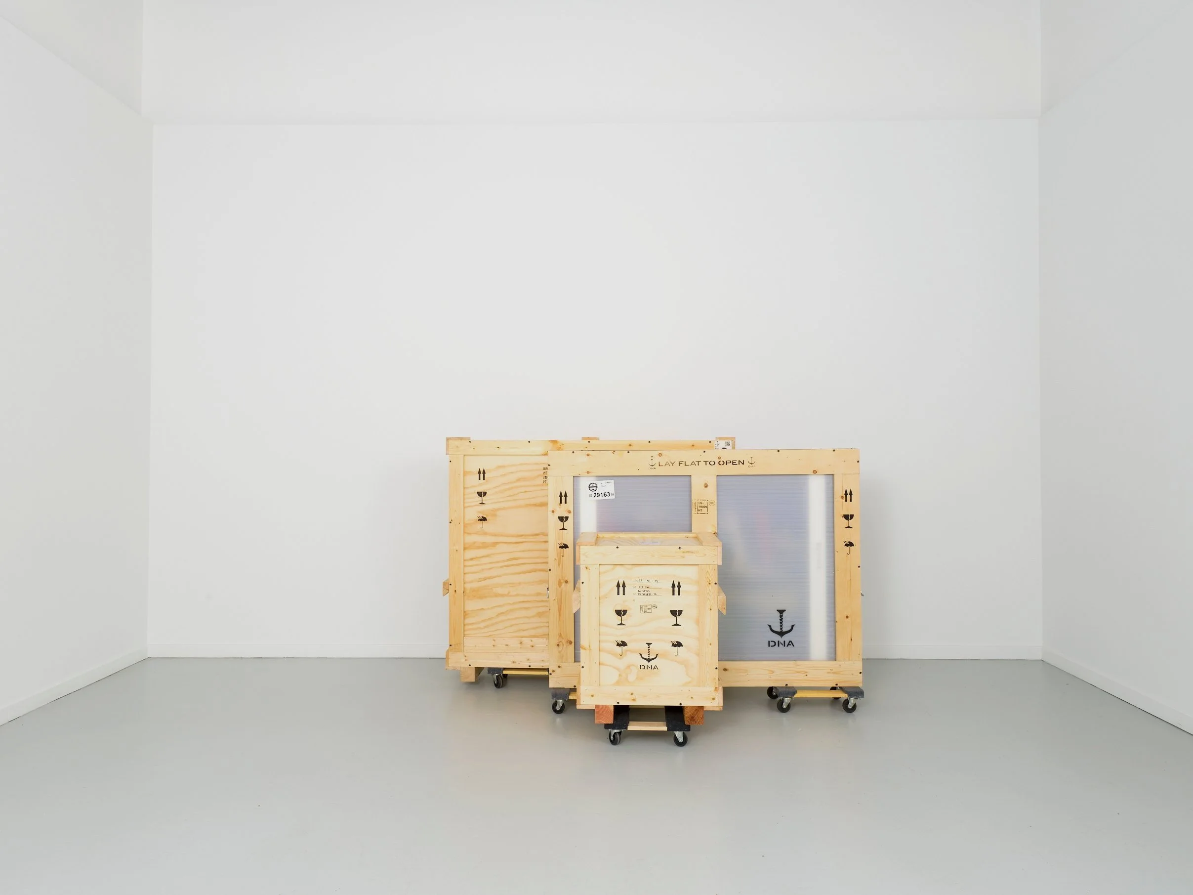 three crates in a white room