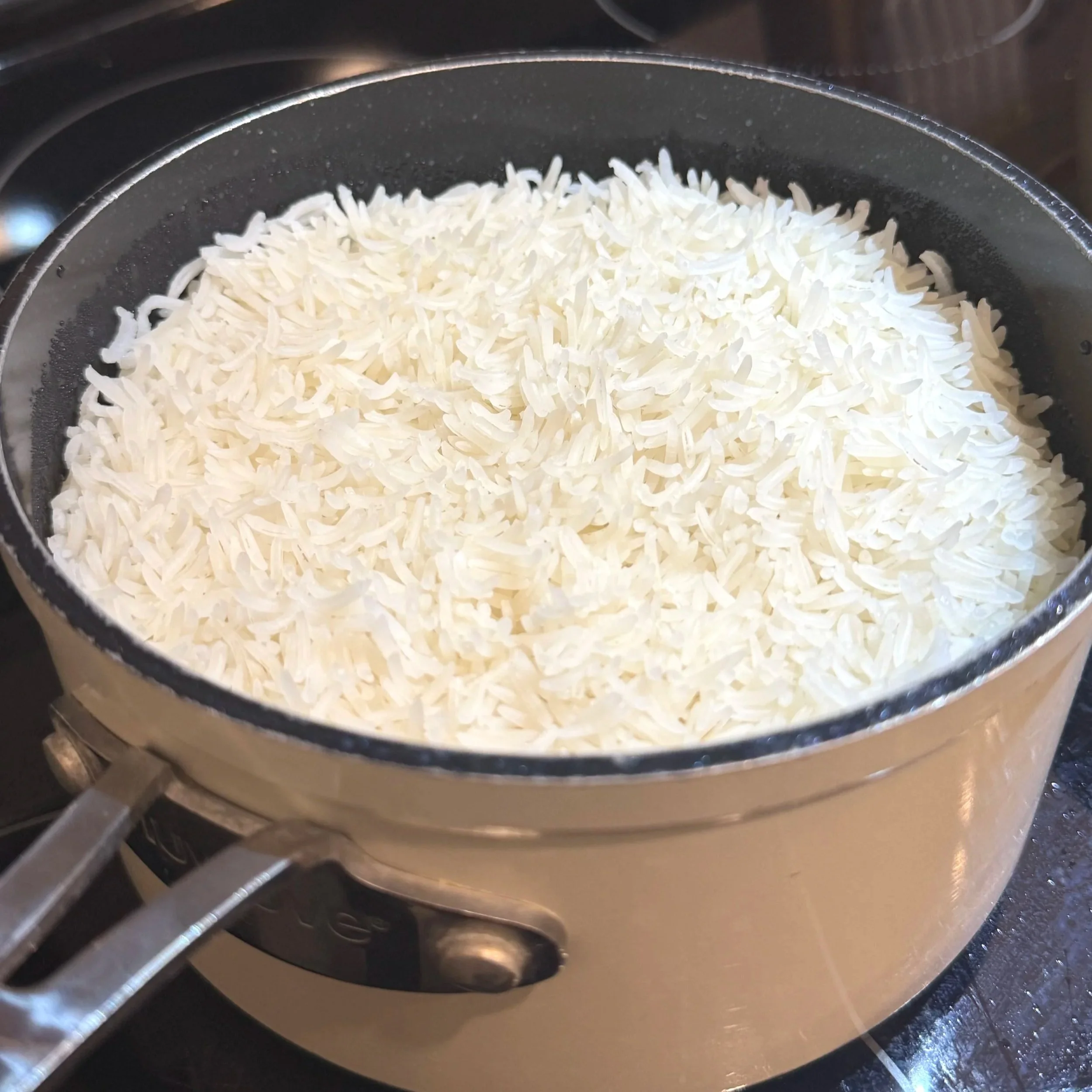 Fluffy white basmati rice served in a bowl, ready to pair with Jamaican curry chicken.